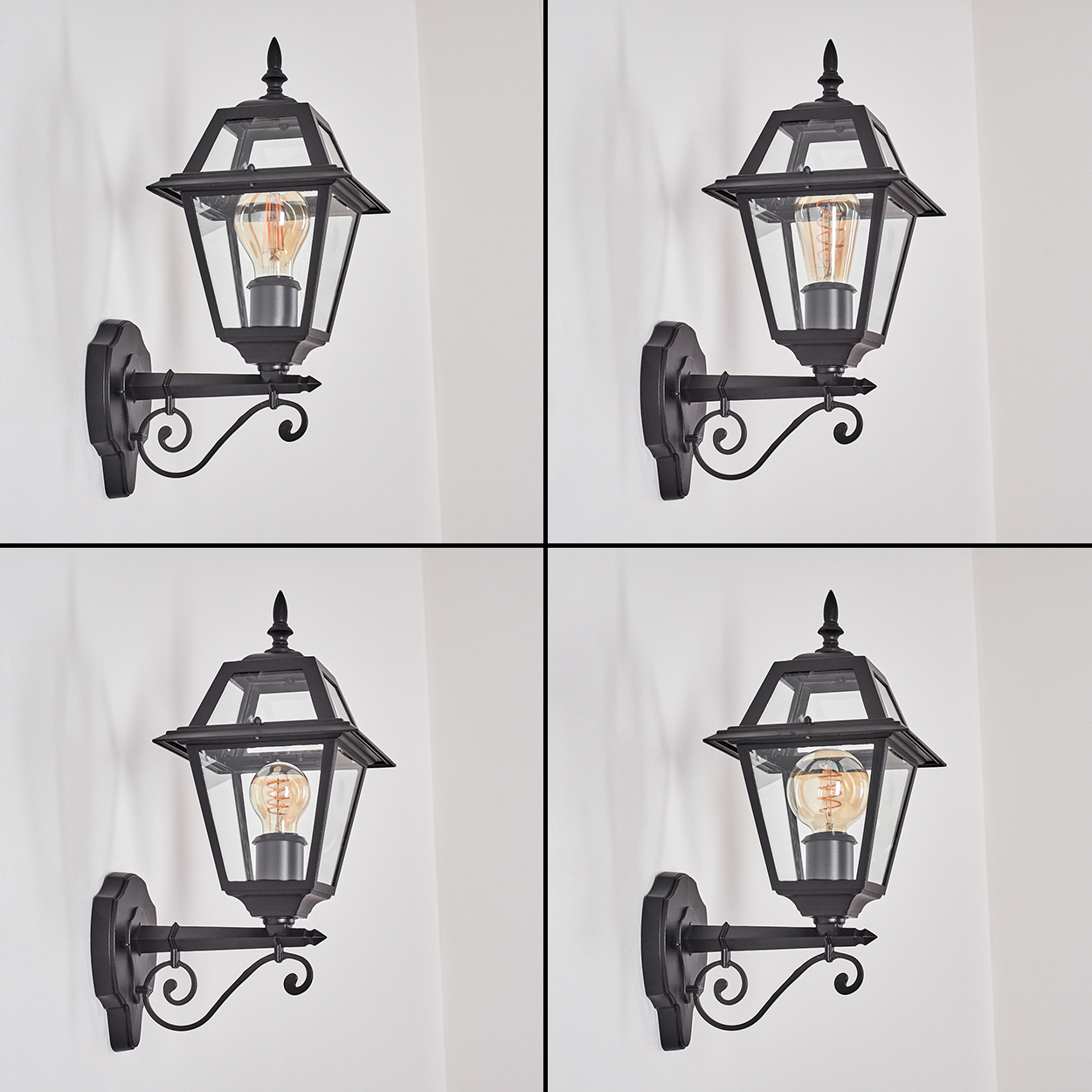 Vier schwarze Außenwandleuchten mit Glasscheiben und einer Glühbirne, an einer weißen Wand befestigt. Verziertes Design.