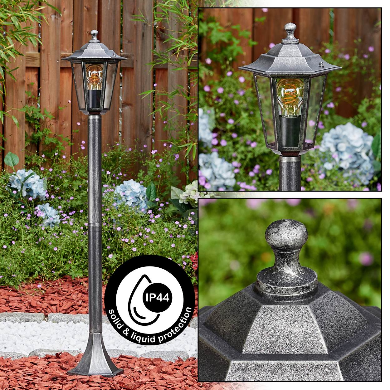 Laternenpfahl im Freien. Silberfarbenes Metall mit Glaseinfassung für die Glühbirne. Aufgestellt in einem Garten mit Blumen und Holzzaun.