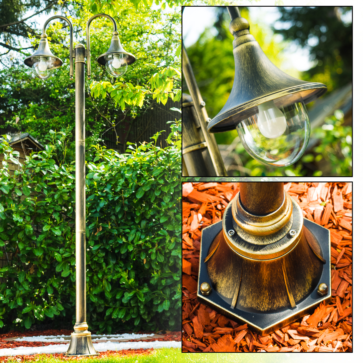 Eine dekorative Außenlampe mit zwei Lichtern. Sie ist goldfarben und befindet sich in einem Garten mit Holzschnitzeln und grünen Büschen.