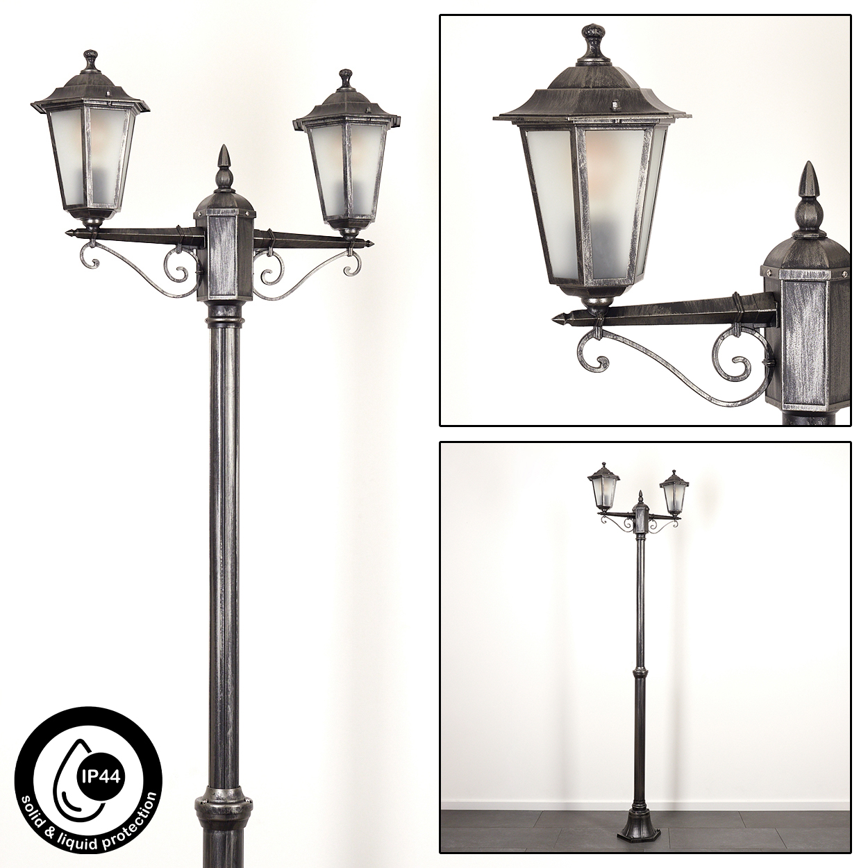 Eine metallische, verzierte Straßenlaterne mit drei Leuchten. Die Lampe ist dunkelgrau mit Milchglas. Sie steht vor weißem Hintergrund.