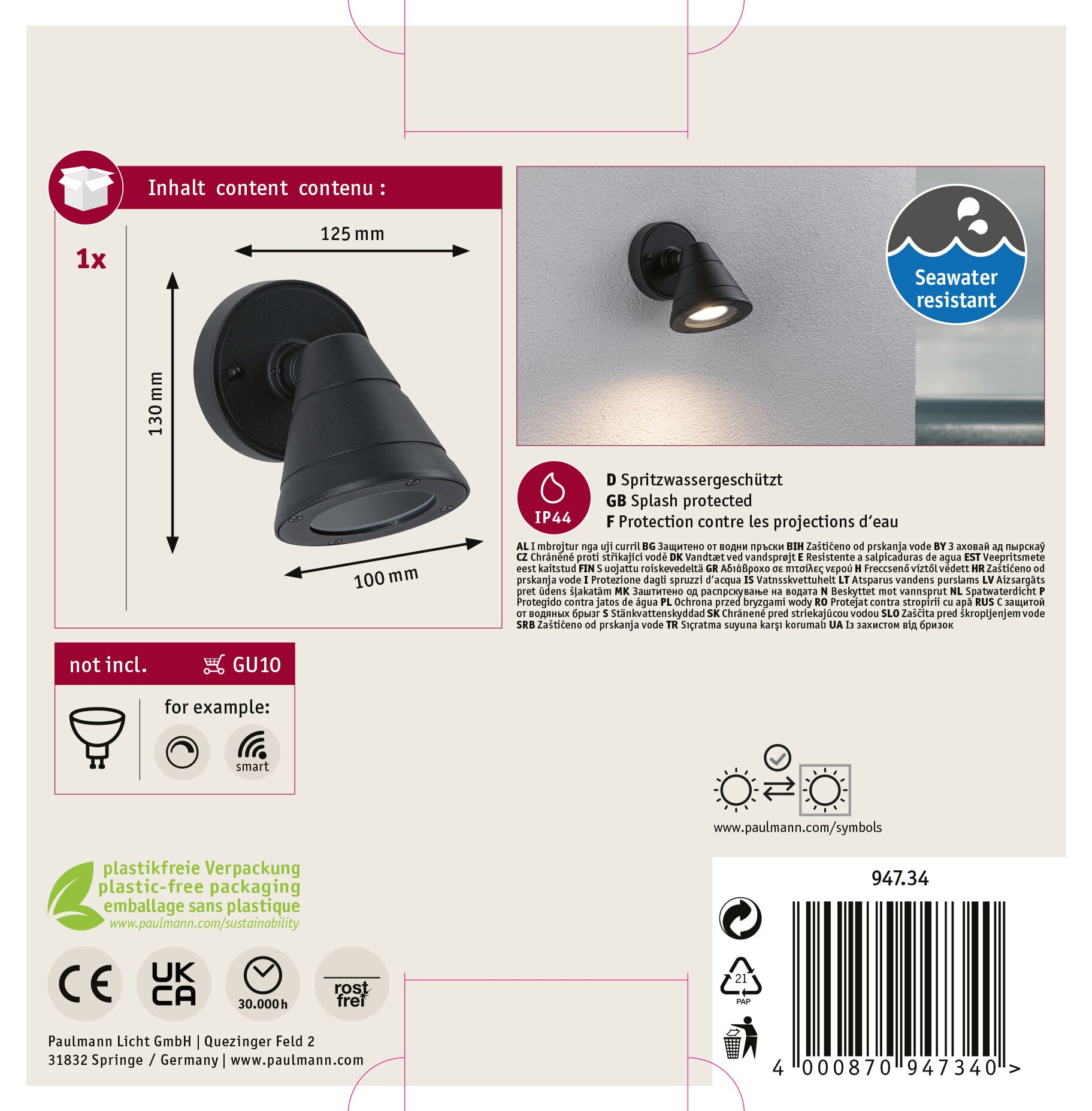Czarny reflektor zewnętrzny z okrągłą podstawą, kątową głowicą i światłem skierowanym do przodu, widoczne jest również opakowanie produktu.