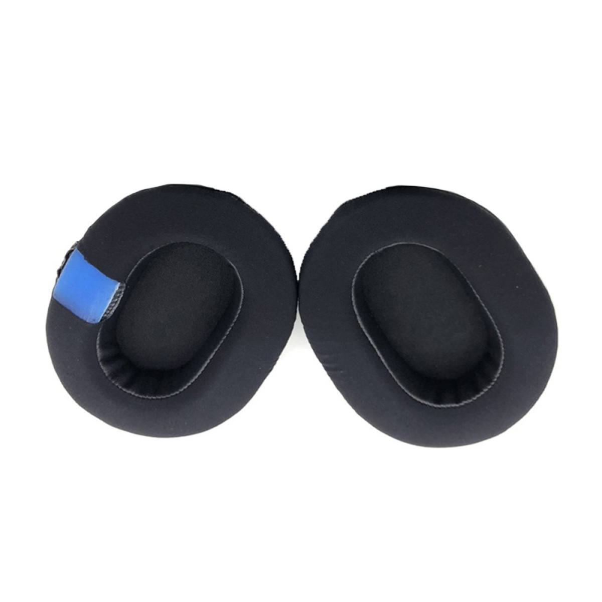 Two black ear pads for headphones, oval-shaped with a blue adhesive tab on one. White background.