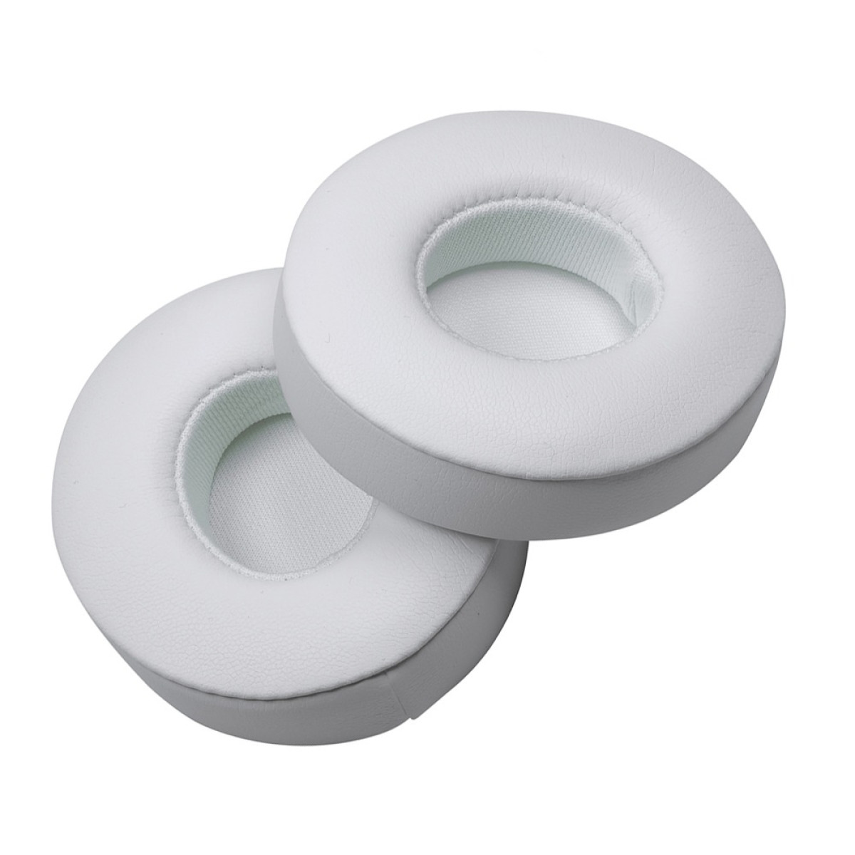 Two white, circular ear pads for headphones, with a central opening. They are positioned against a white background.
