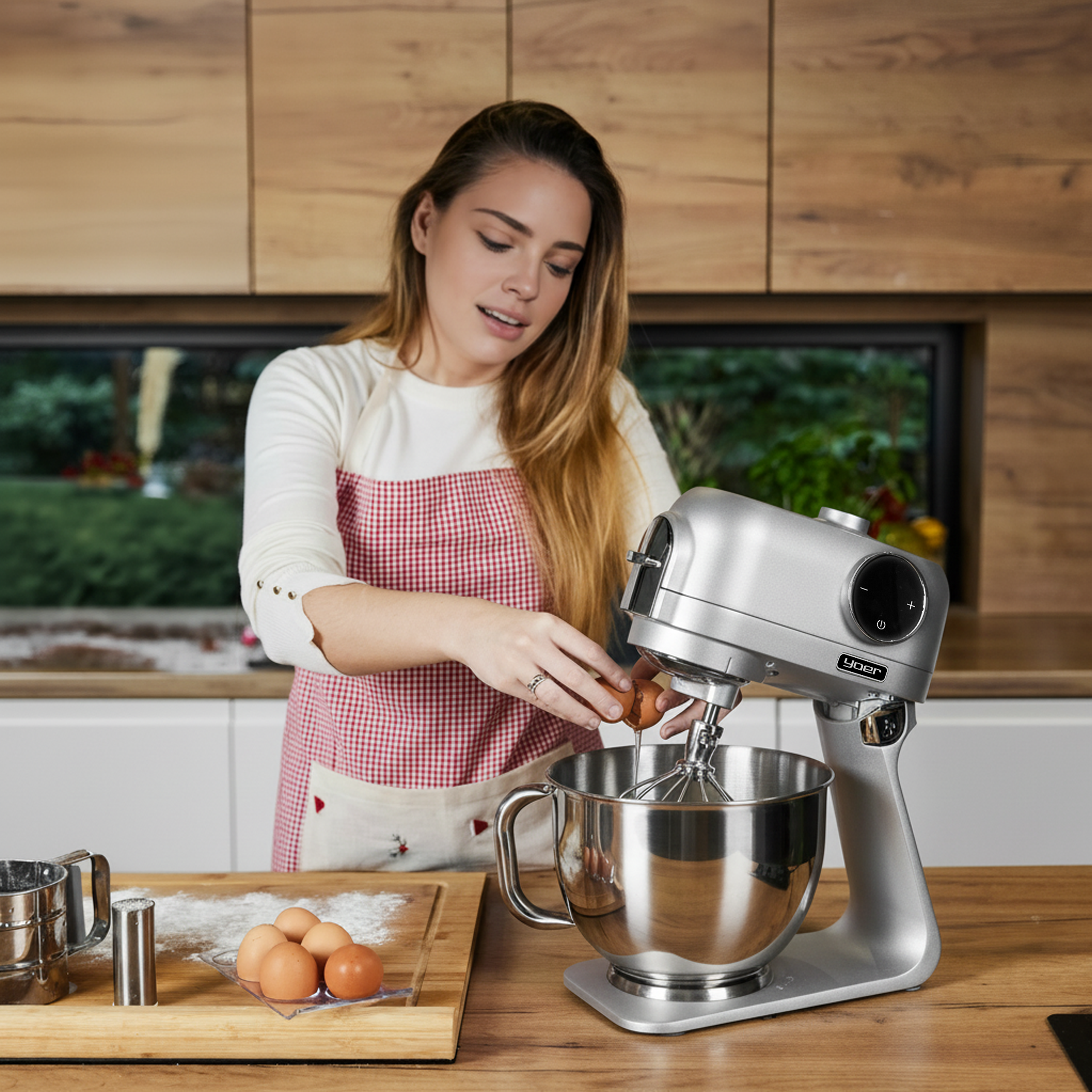 Kobieta wbija jajka do miksera. Scena kuchenna z drewnianymi powierzchniami i srebrnym mikserem.
