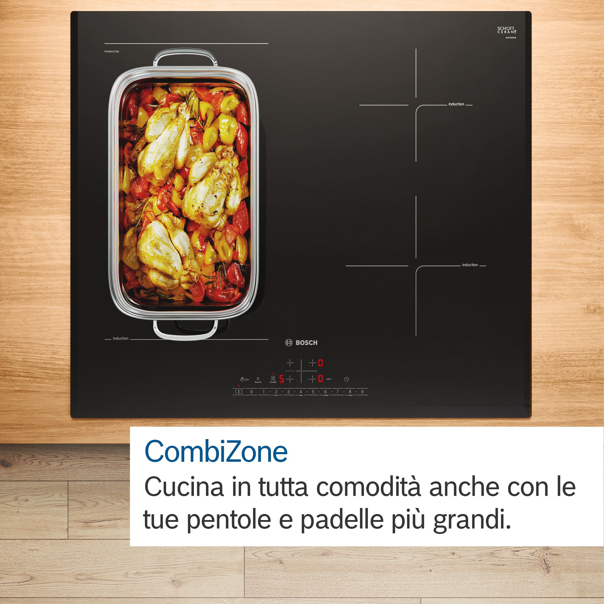 Nowoczesna czarna płyta indukcyjna z tacą z gotowanym kurczakiem i warzywami na drewnianej powierzchni.