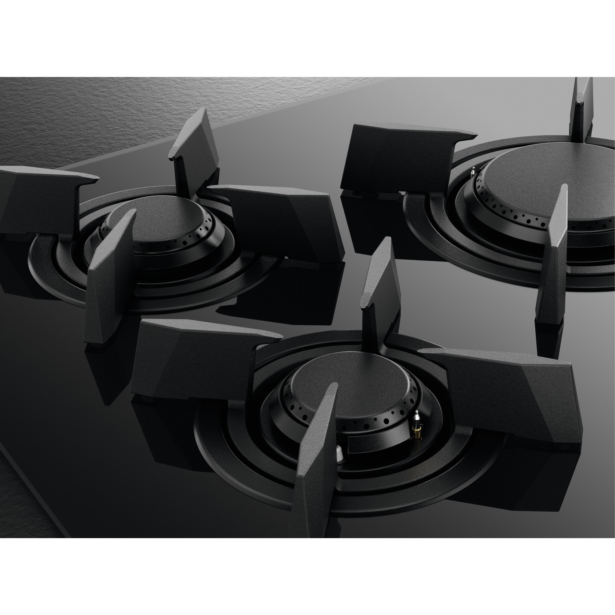 Primer plano de una cocina de gas negra con cuatro quemadores. La superficie es brillante y refleja la luz. Cada quemador tiene una rejilla negra.