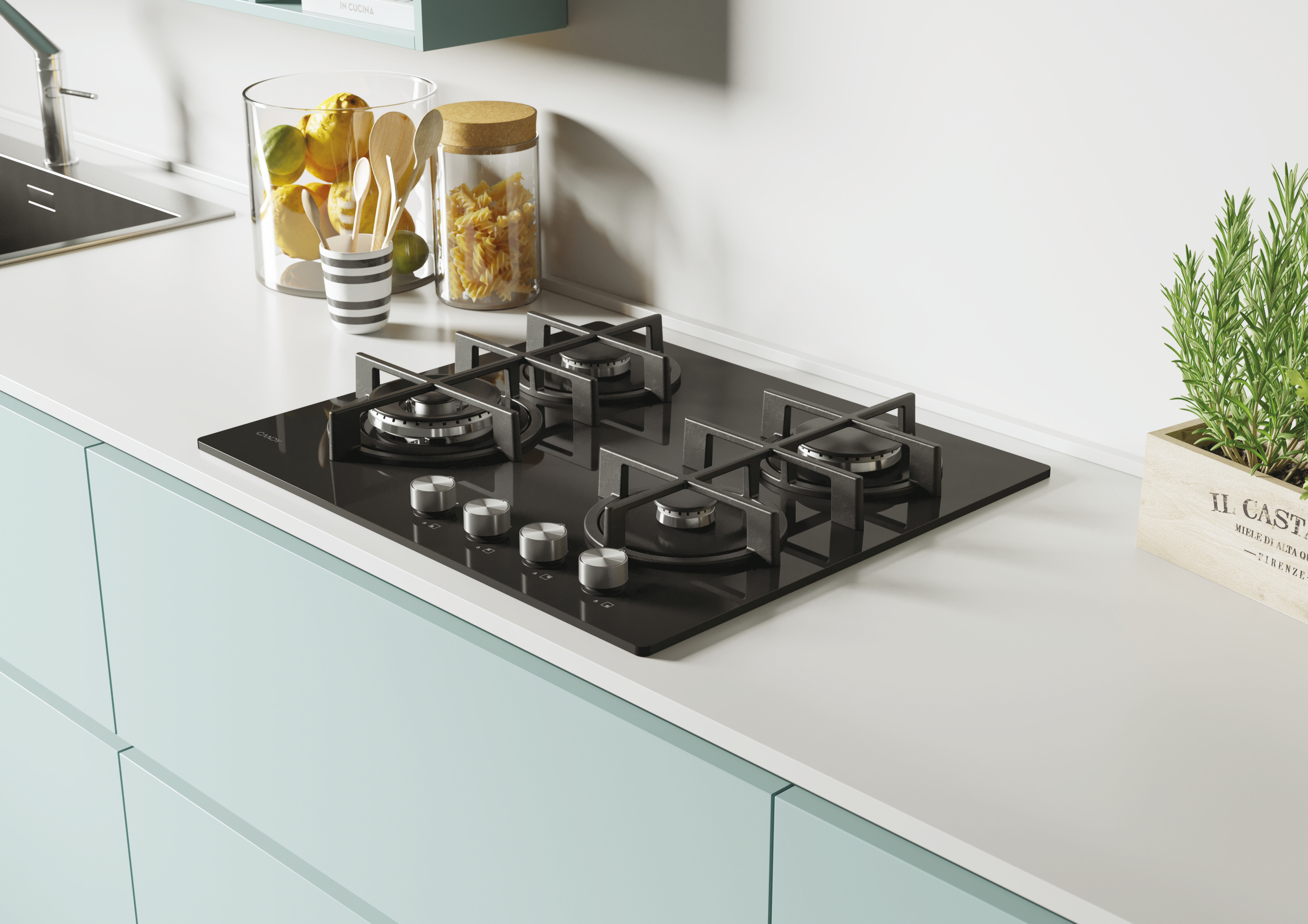 Piano cucina con piano cottura nero, barattoli, pianta e armadietti azzurri. Limoni e pasta visibili.