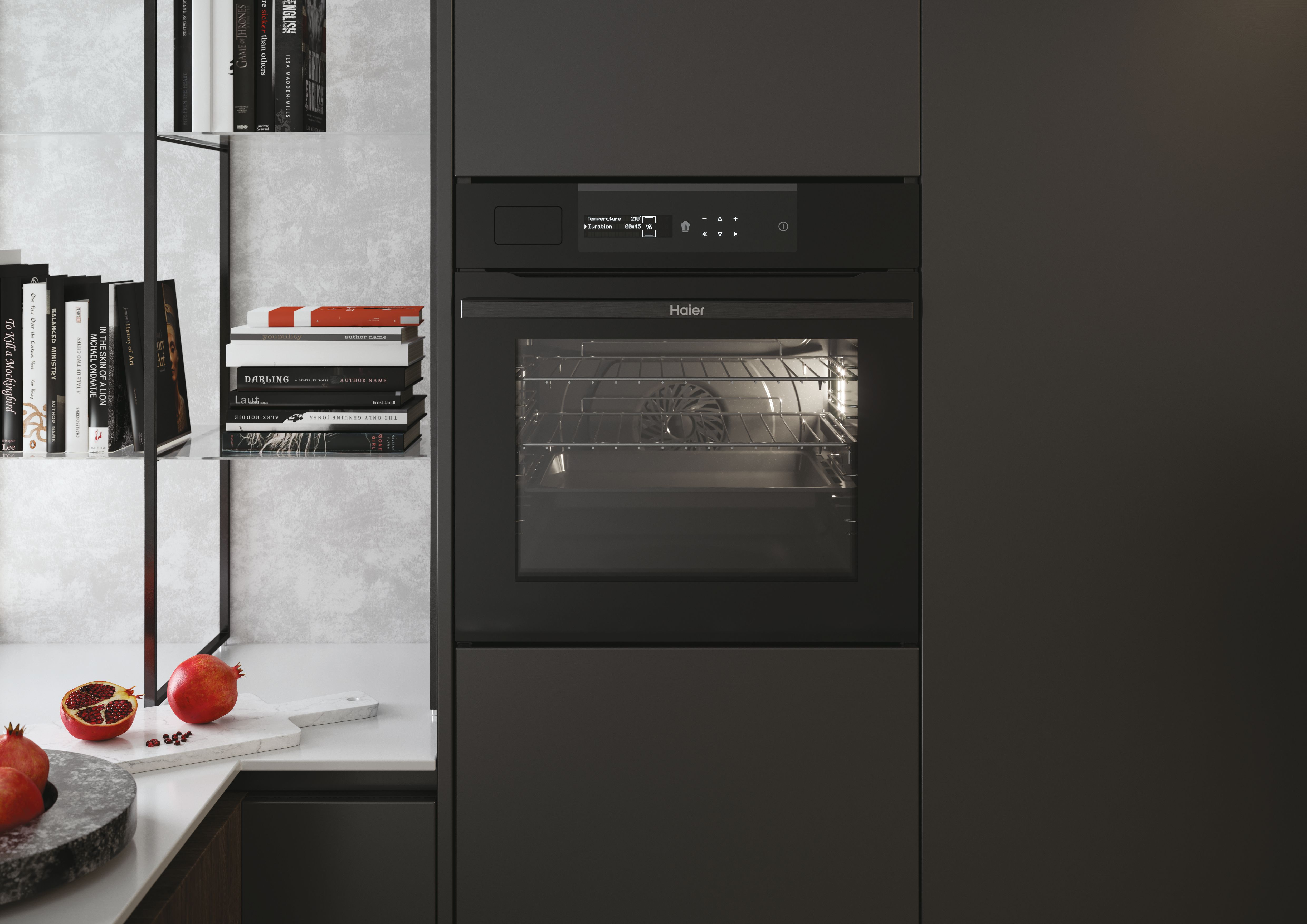 Cocina moderna con horno negro Haier, libros de cocina en estantes y granadas en la encimera.