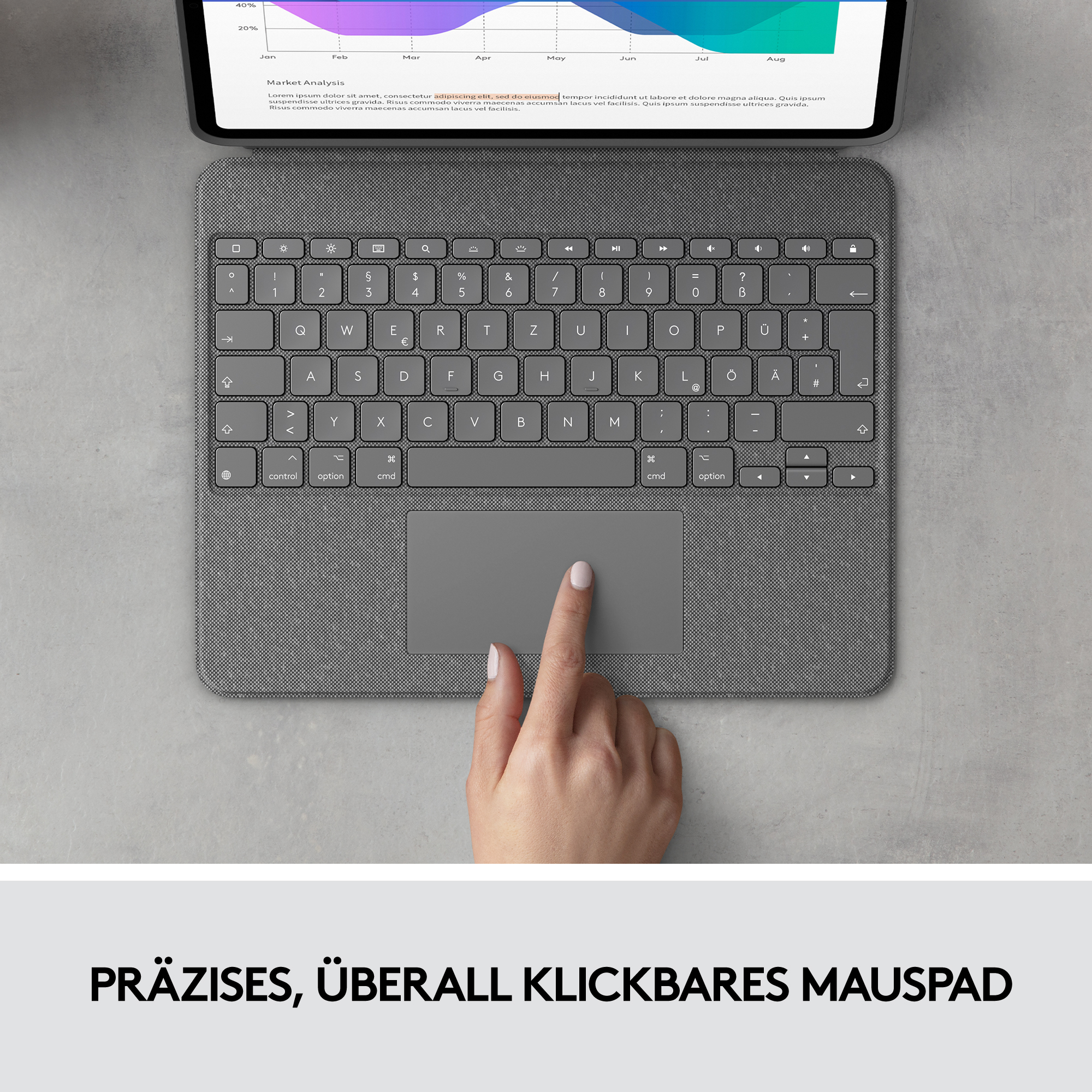 Una mano toca un panel táctil gris en un teclado. Un gráfico es visible en una pantalla encima del teclado.