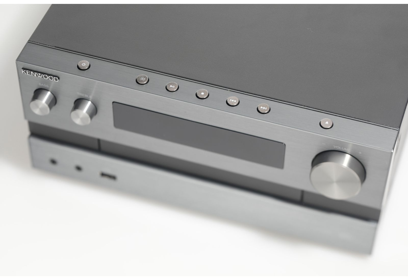 Un ricevitore stereo Kenwood. Ha manopole per bassi, alti e volume. Sono presenti anche pulsanti per l'accensione e il controllo dei media.