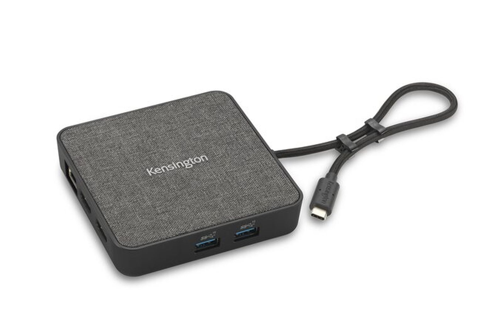 Ein Kensington USB-Hub mit grauem Stoffoberteil und schwarzen Anschlüssen. Ein schwarzes Kabel ist befestigt.