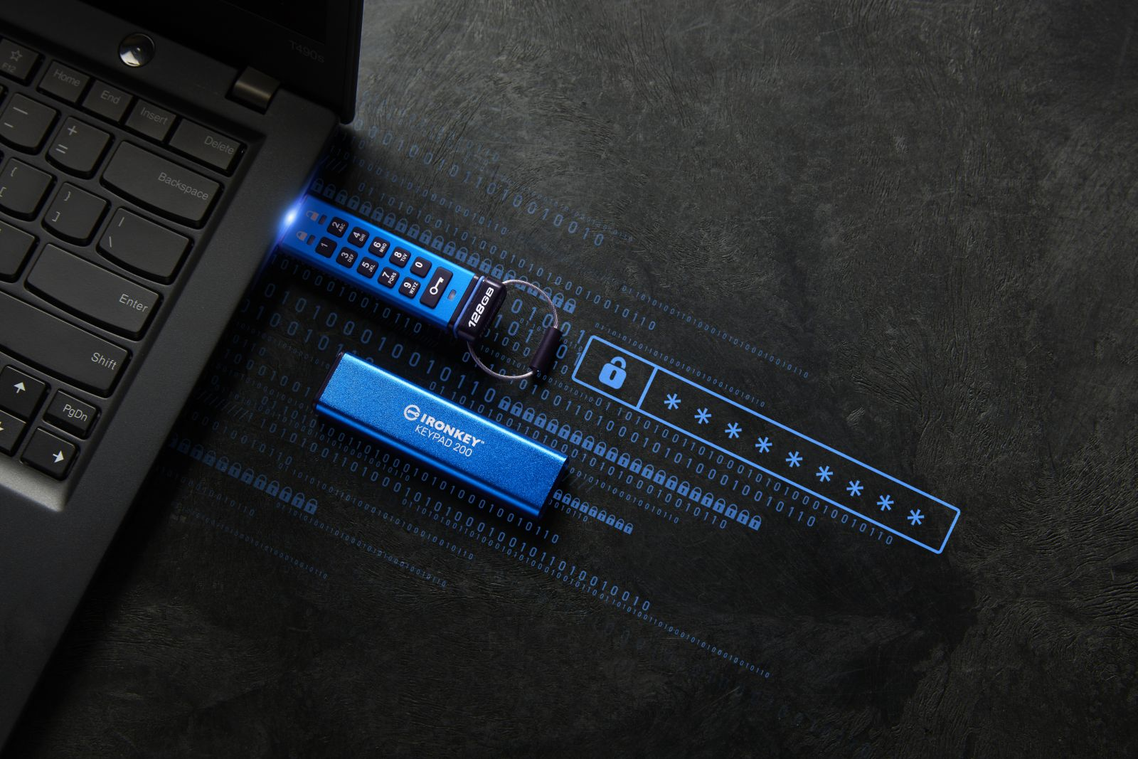 Klawiatura laptopa, niebieska klawiatura IronKey i pole hasła z gwiazdkami na tle kodu binarnego.