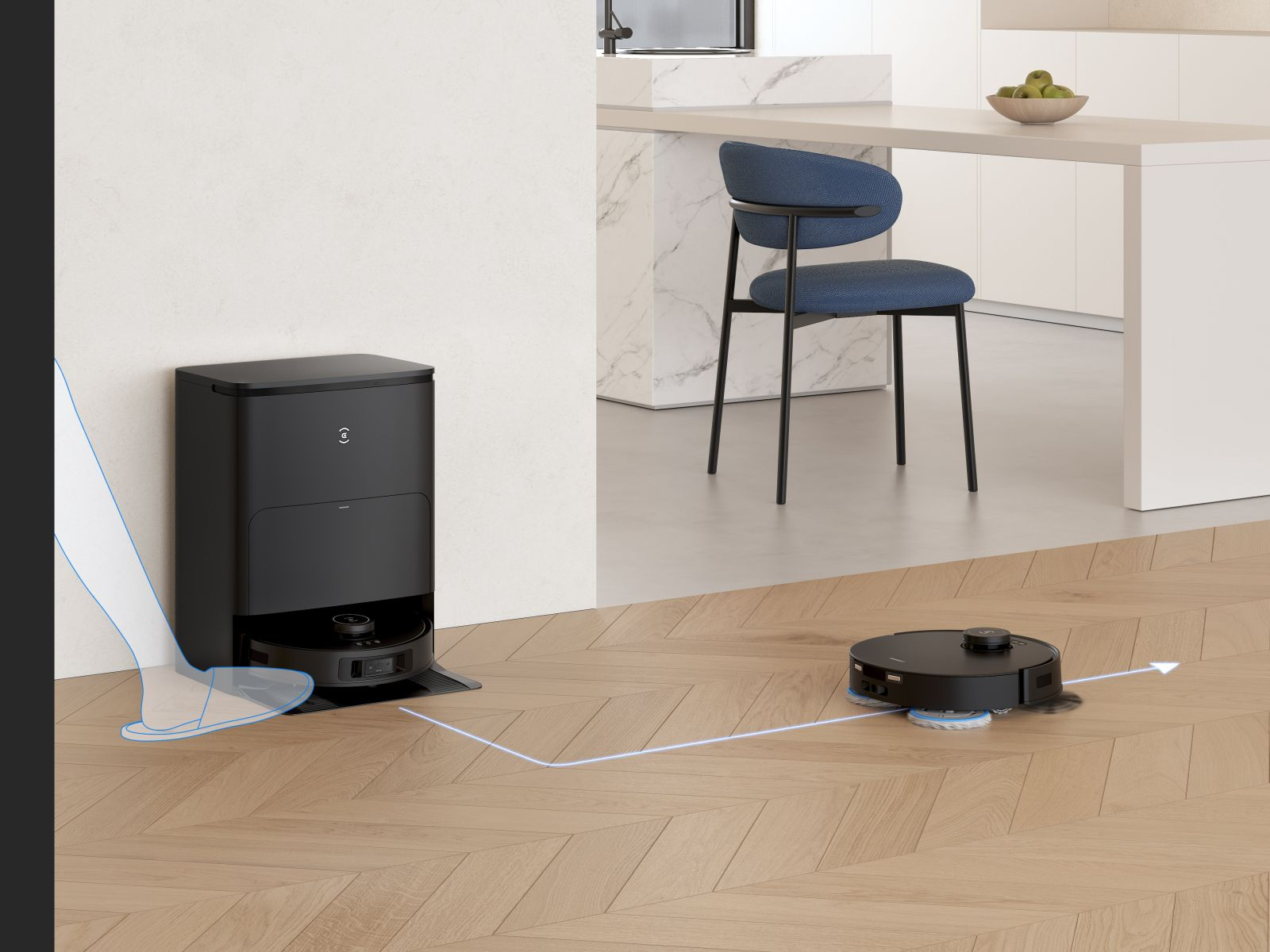 Czarny robot sprząta drewnianą podłogę, z lewej stacją ładującą i krzesłem w tle.