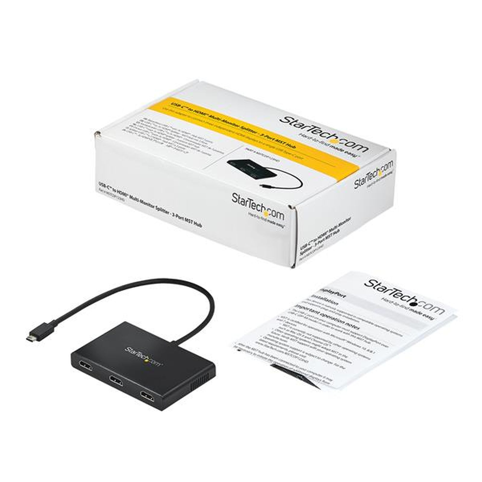 Una caja blanca con un dispositivo negro y un cable, un papel. Todo está sobre una superficie blanca.
