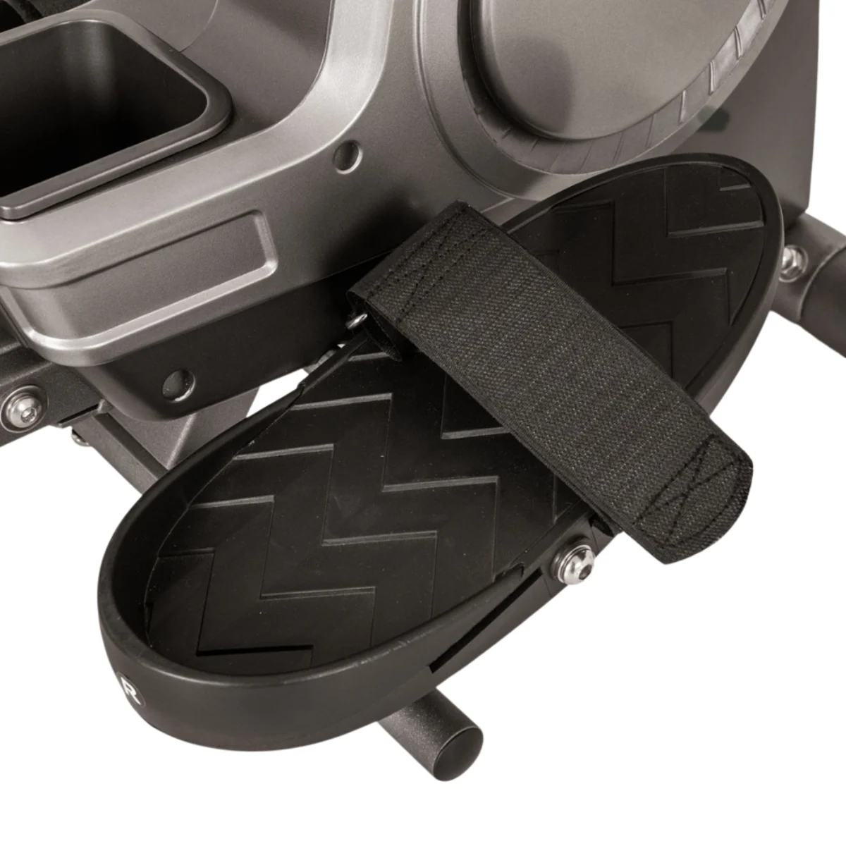 Nahaufnahme eines Pedals einer Ellipsenmaschine. Schwarze, strukturierte Fußstütze mit Riemen, grauer Maschinenrahmen im Hintergrund.
