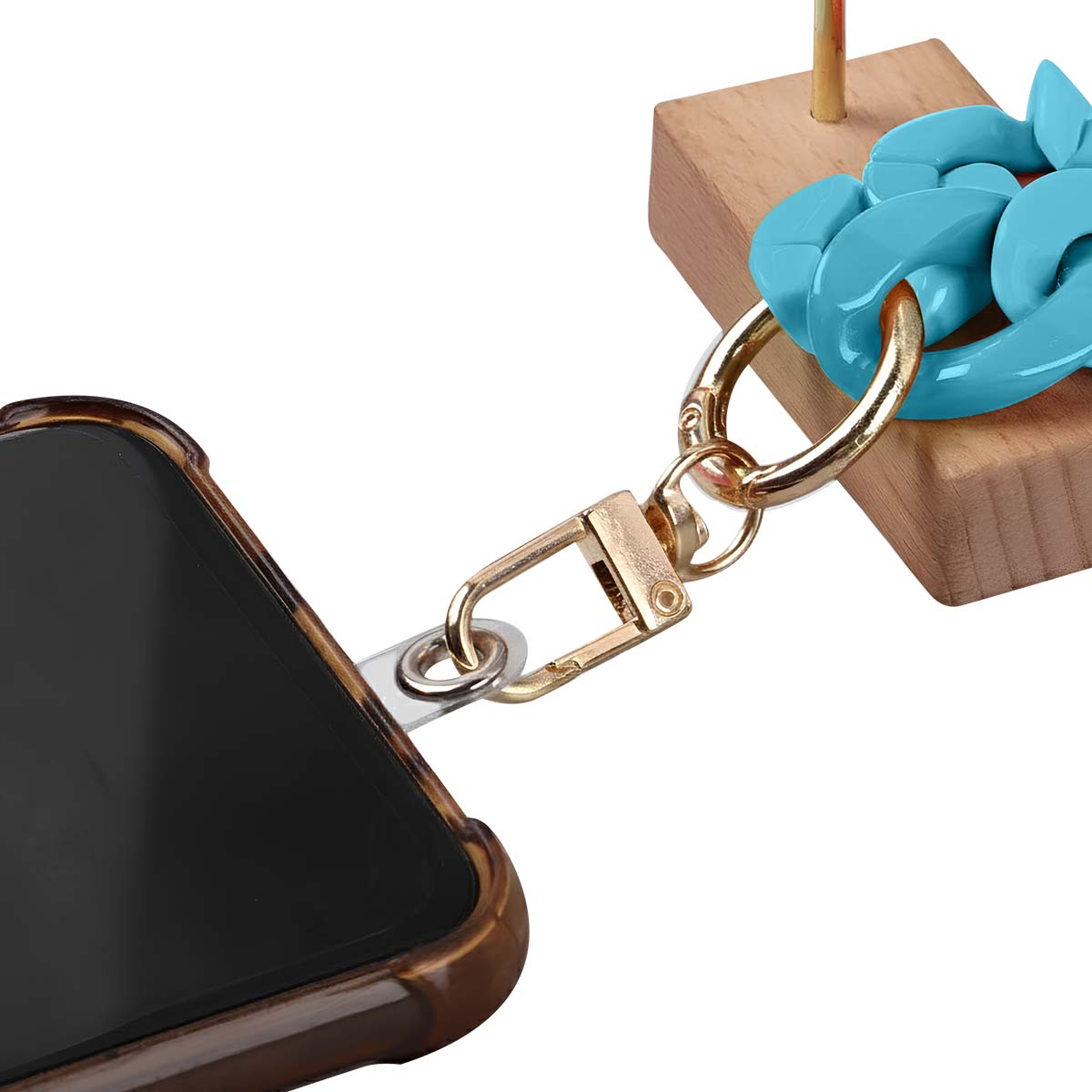 Una custodia per telefono è collegata a una catena d'oro con un anello blu. La custodia ha un motivo marrone. Lo sfondo è bianco.