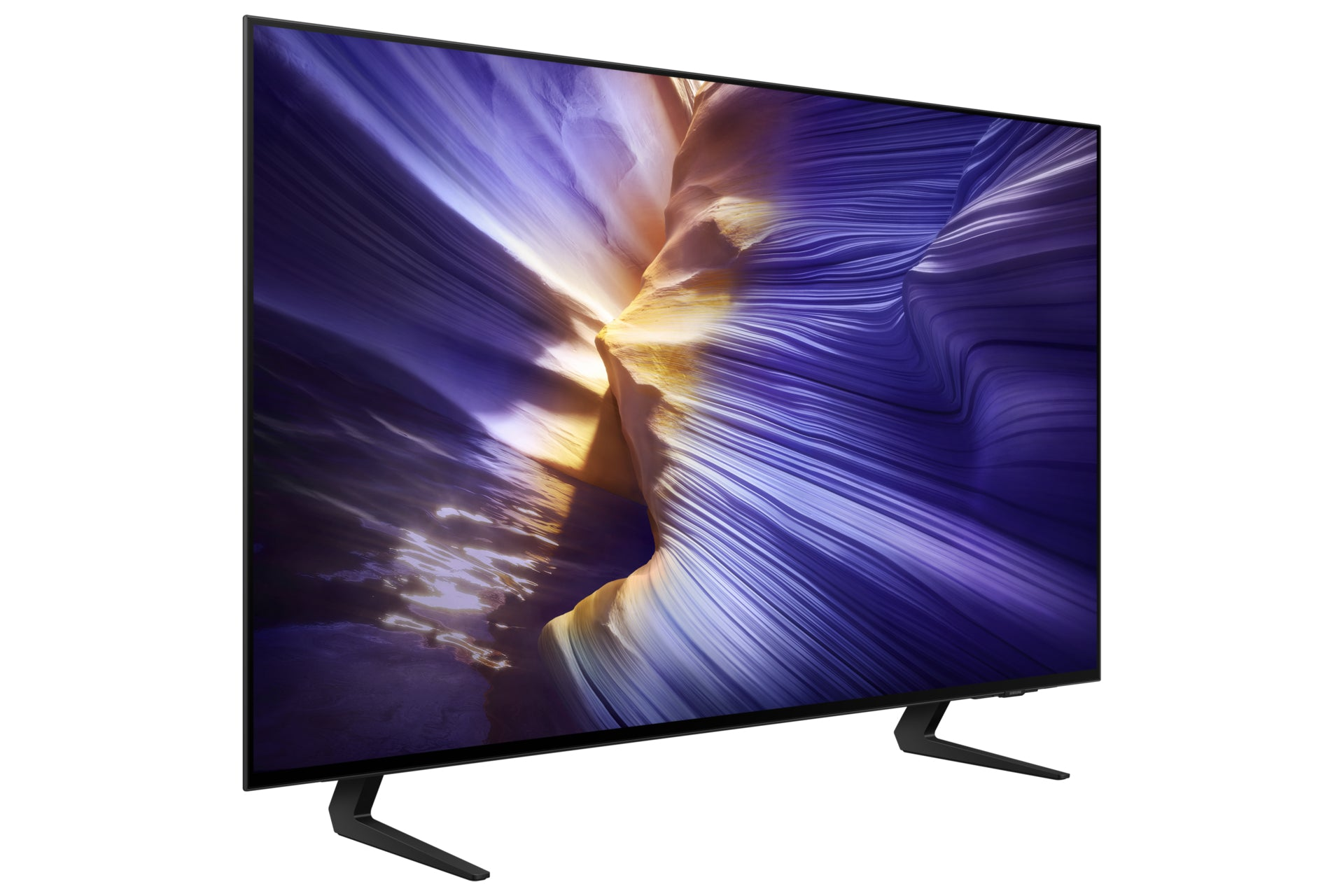 Une télévision moderne affiche un paysage violet et or. Elle repose sur des pieds noirs sur fond blanc.