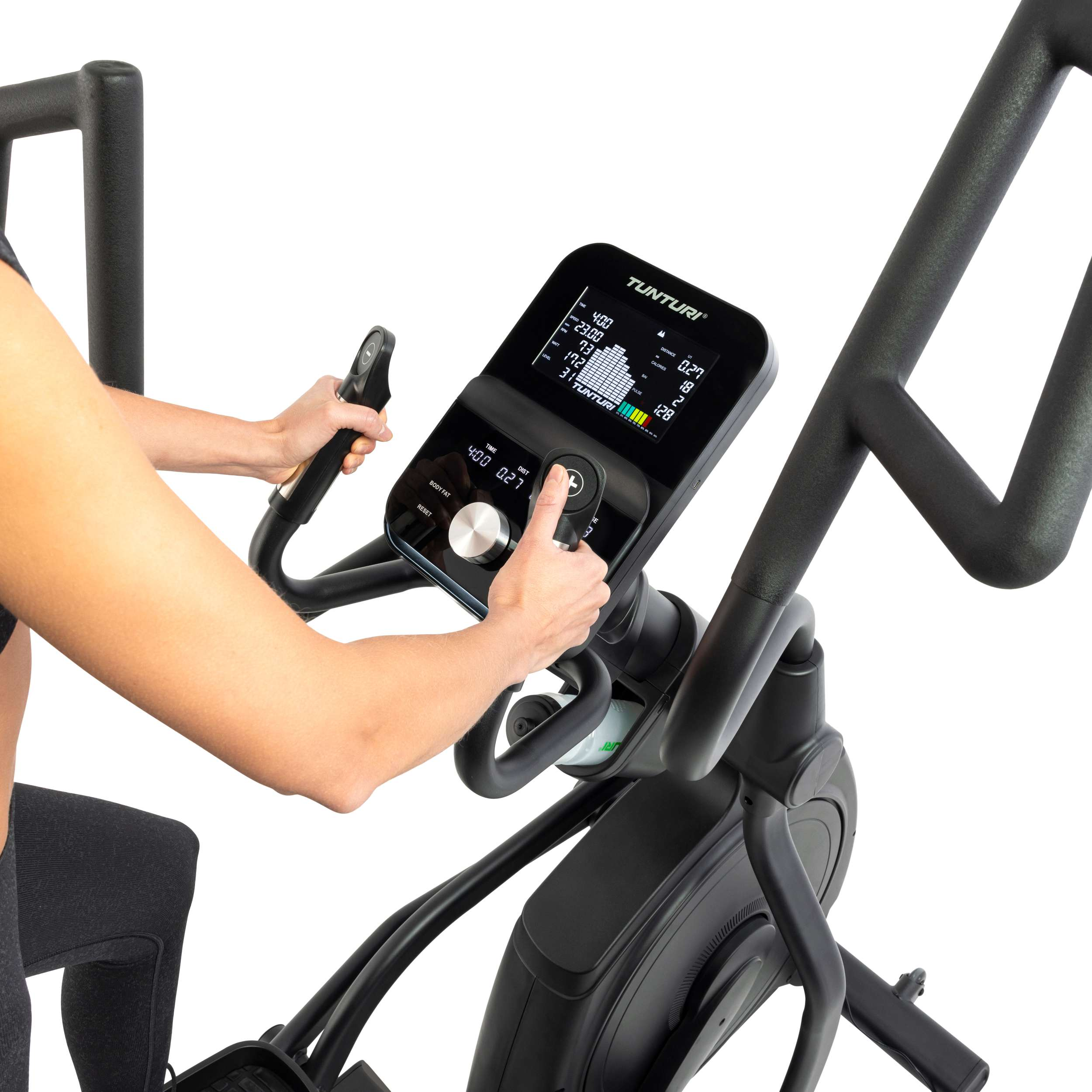 A person uses a Tunturi elliptical machine. Hands operate the console. Display shows stats. Black and gray colors dominate.