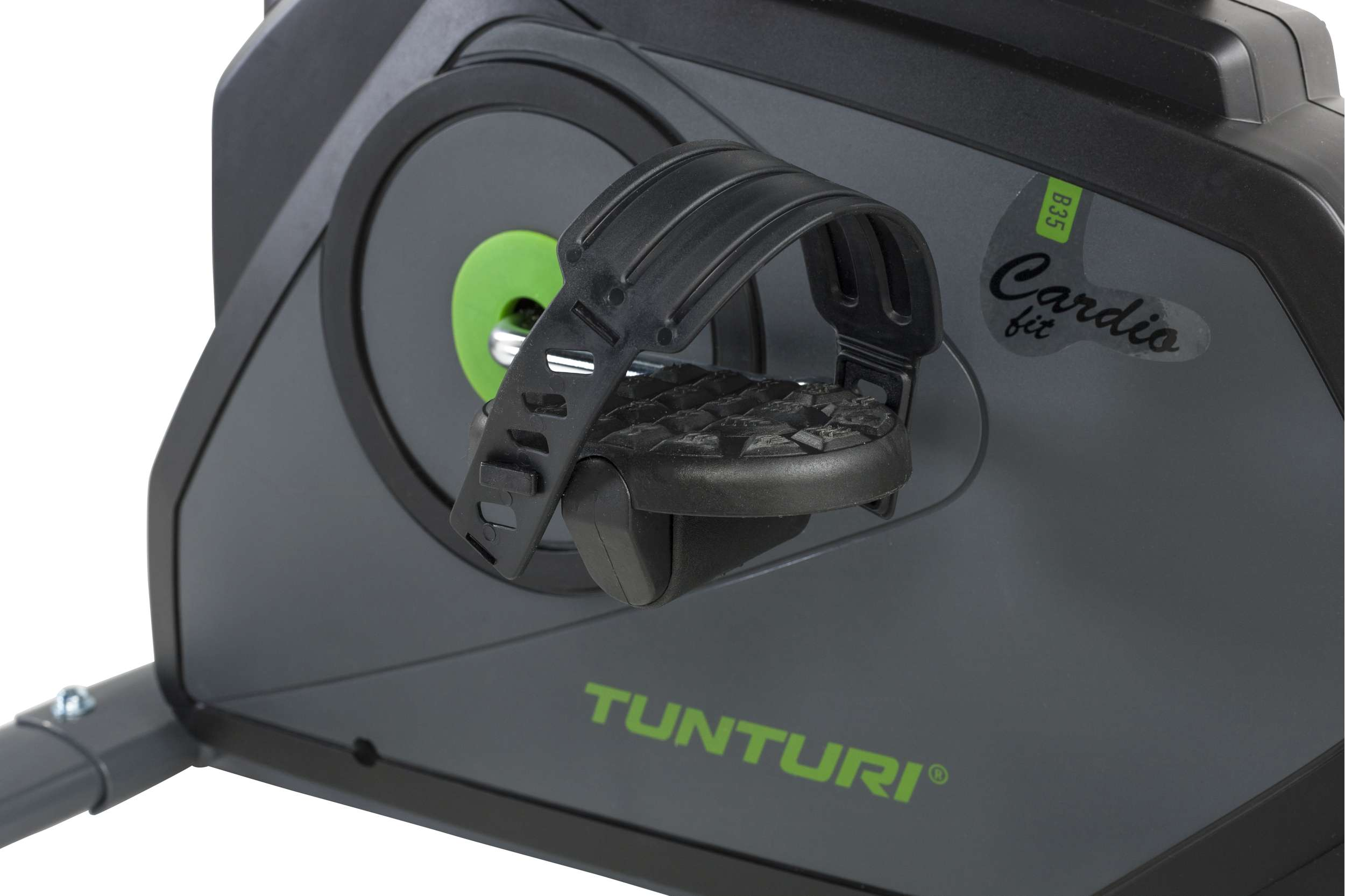Close-up of a black exercise bike pedal. The bike has gray accents and green text. The pedal is black and textured.