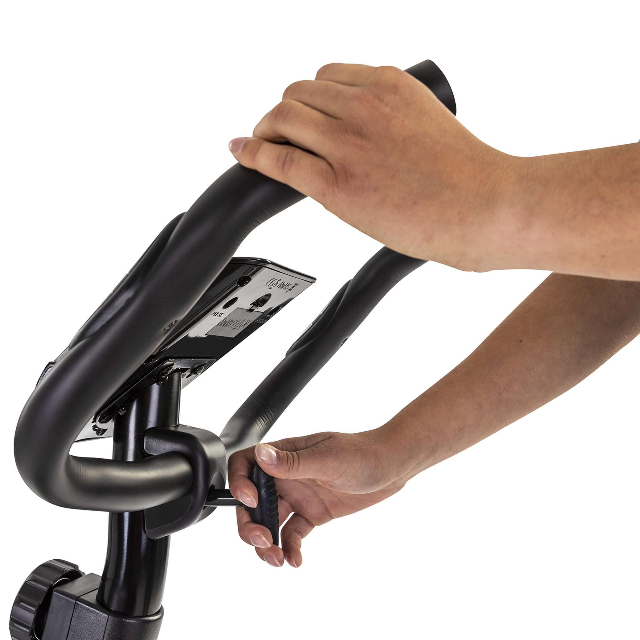 Hands hold the black handlebar of an exercise bike. The background is white.