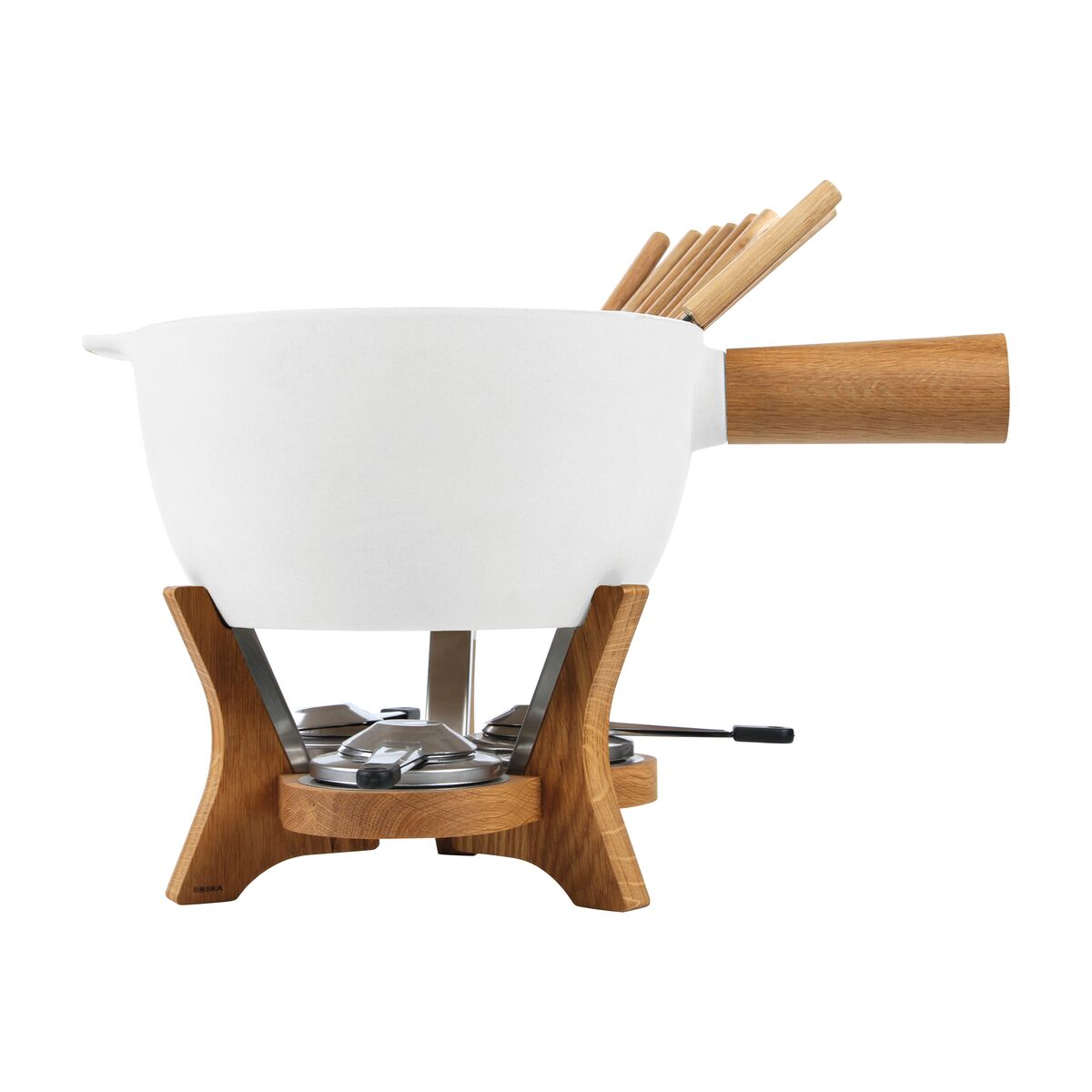 A white fondue pot with wooden handle and stand. Wooden skewers are in the pot. The stand is made of wood and metal.