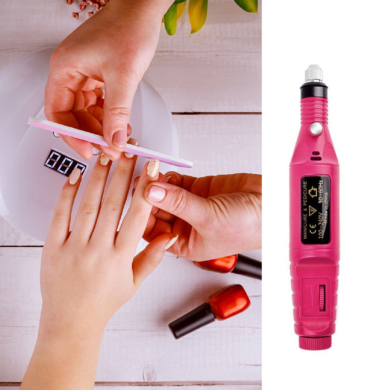 Maniküre im Gange. Hände mit Nagelfeile, Nagellackflaschen und einem rosa elektrischen Nagelbohrer auf weißem Hintergrund.