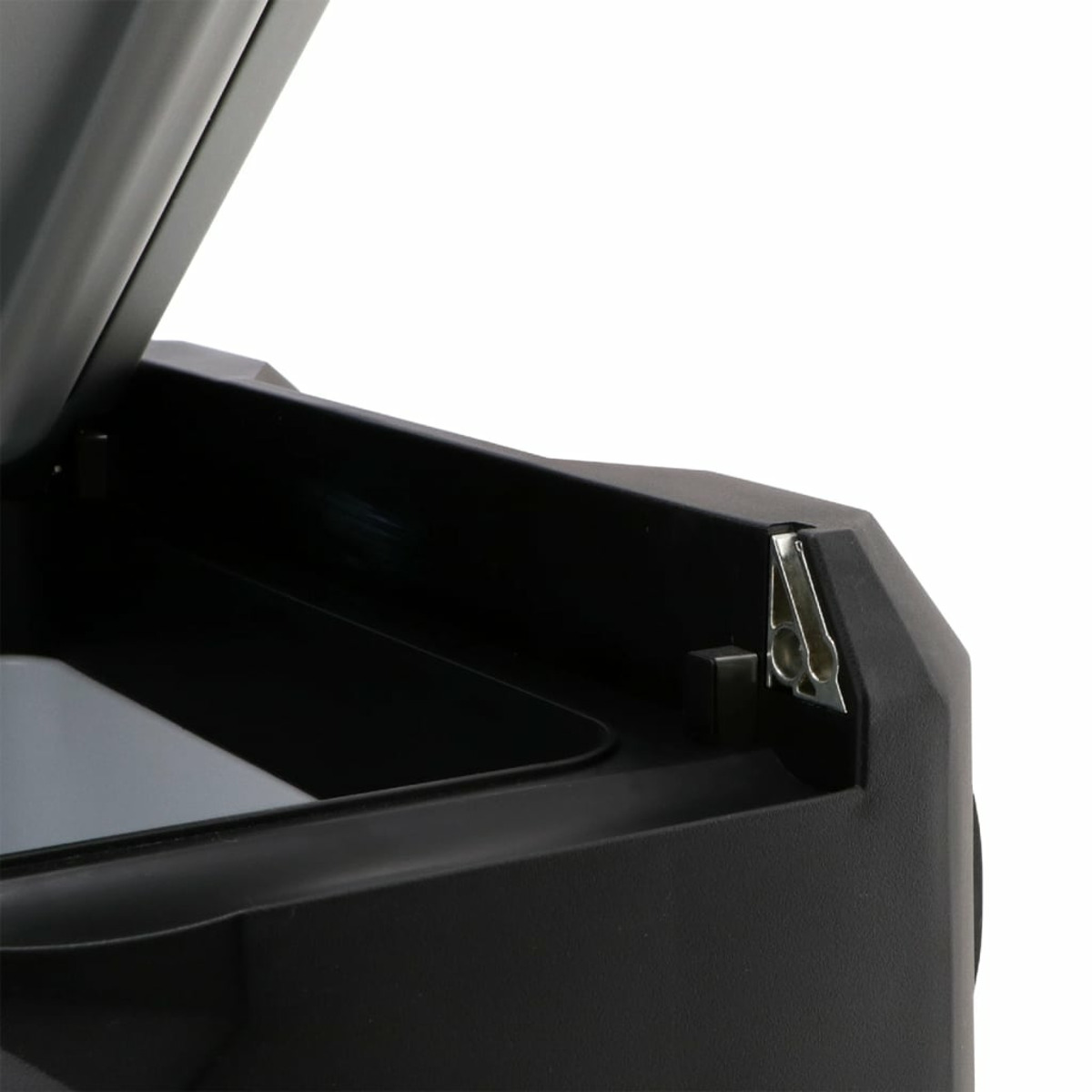 Close-up of a black object with an open lid, showing a metal hinge and a glimpse of the interior. White background.