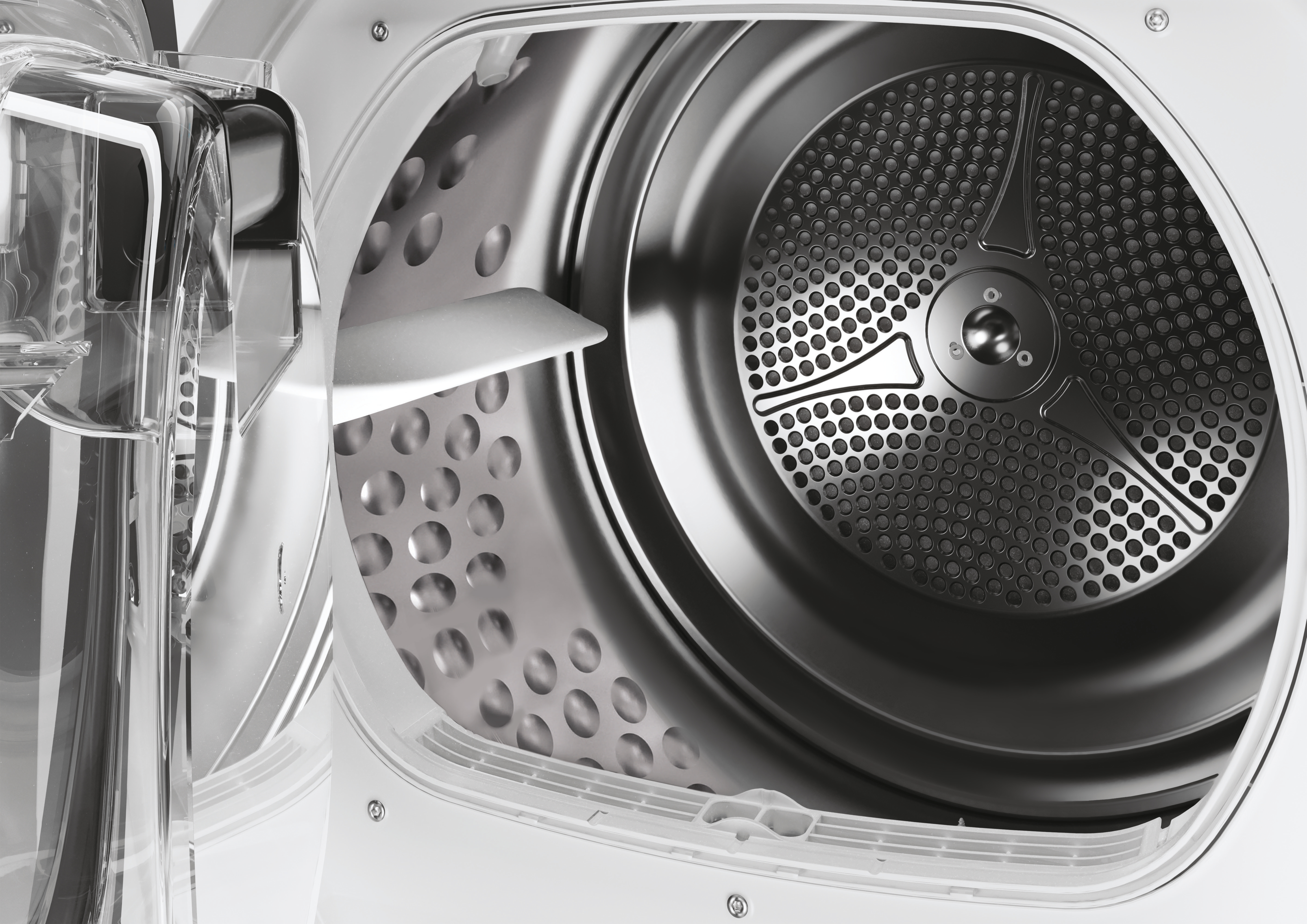 Inside of a dryer machine. The drum is perforated. The door is open, showing the inside components.