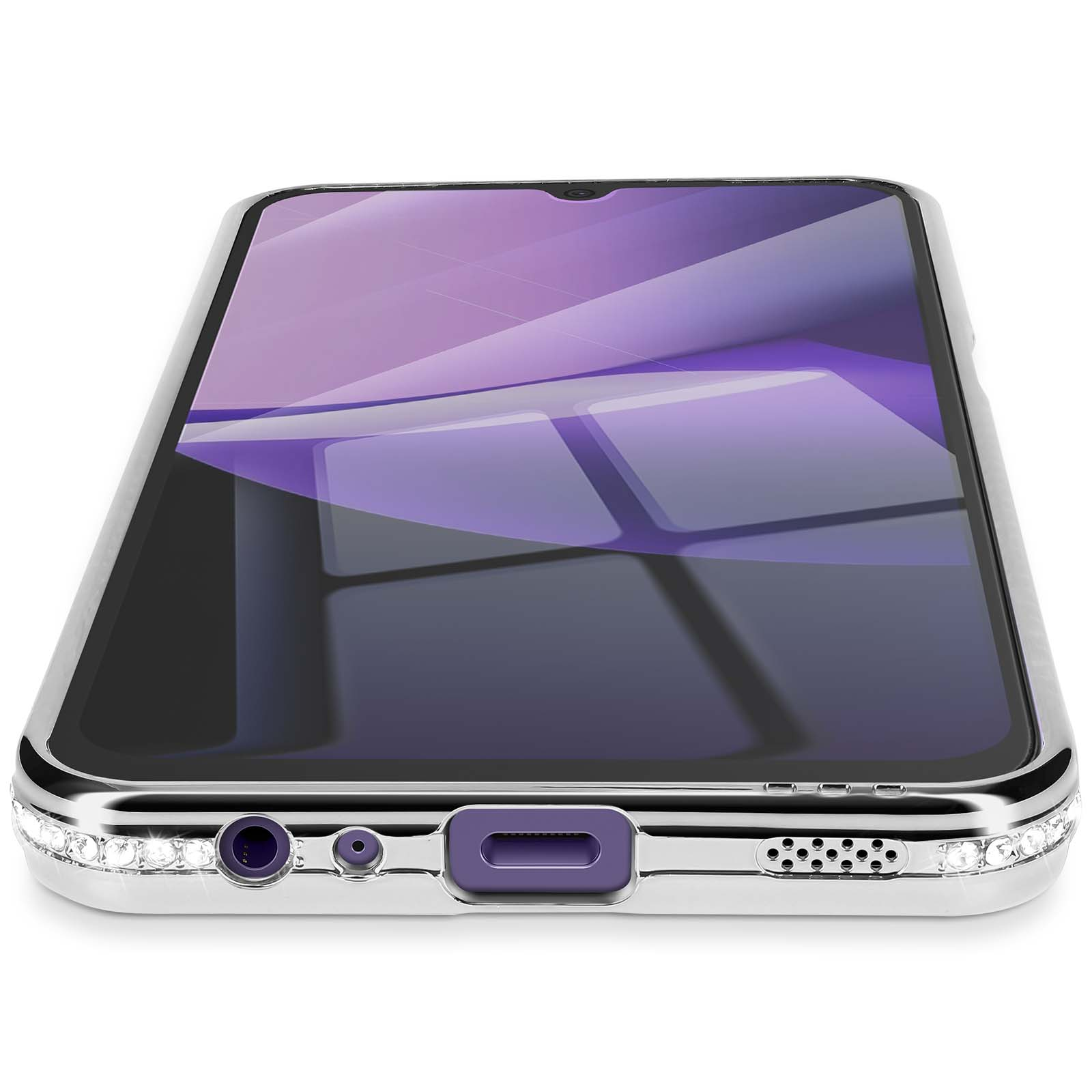Een smartphone in een zilveren hoesje met een paars scherm. De hoes heeft kristallen accenten en poortdetails. Witte achtergrond.