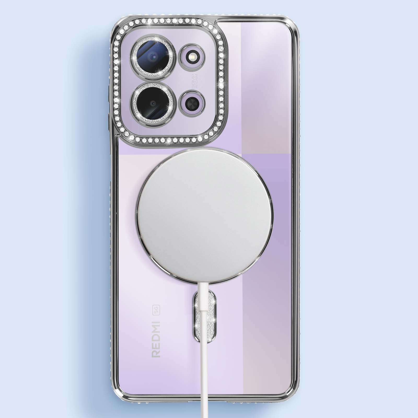 Een telefoonhoesje met een magnetische oplader. De hoes is transparant met een met edelstenen bezette camerabehuizing en een witte oplaadschijf.