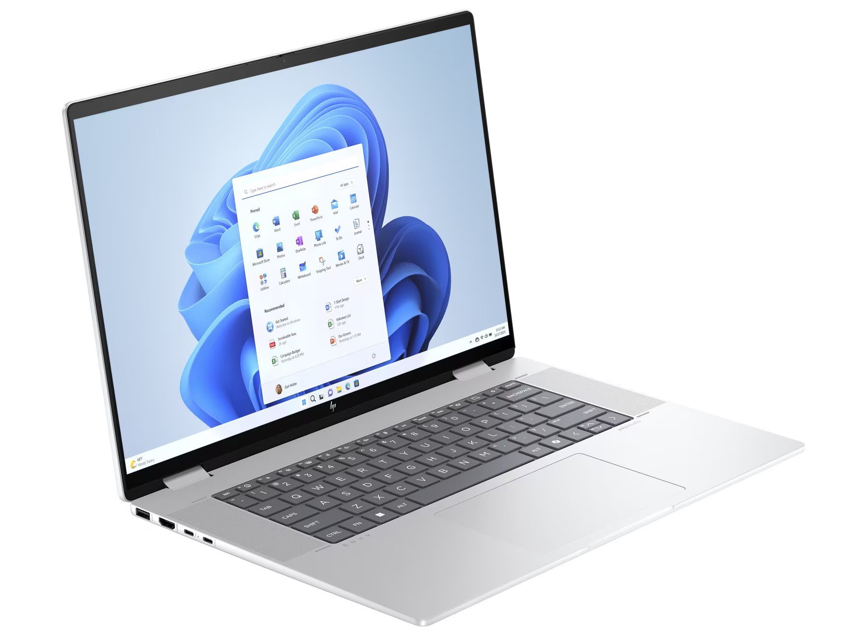 Ein silberner Laptop zeigt eine Windows 11-Oberfläche. Der Bildschirm zeigt das Startmenü. Tastatur und Touchpad sind sichtbar.