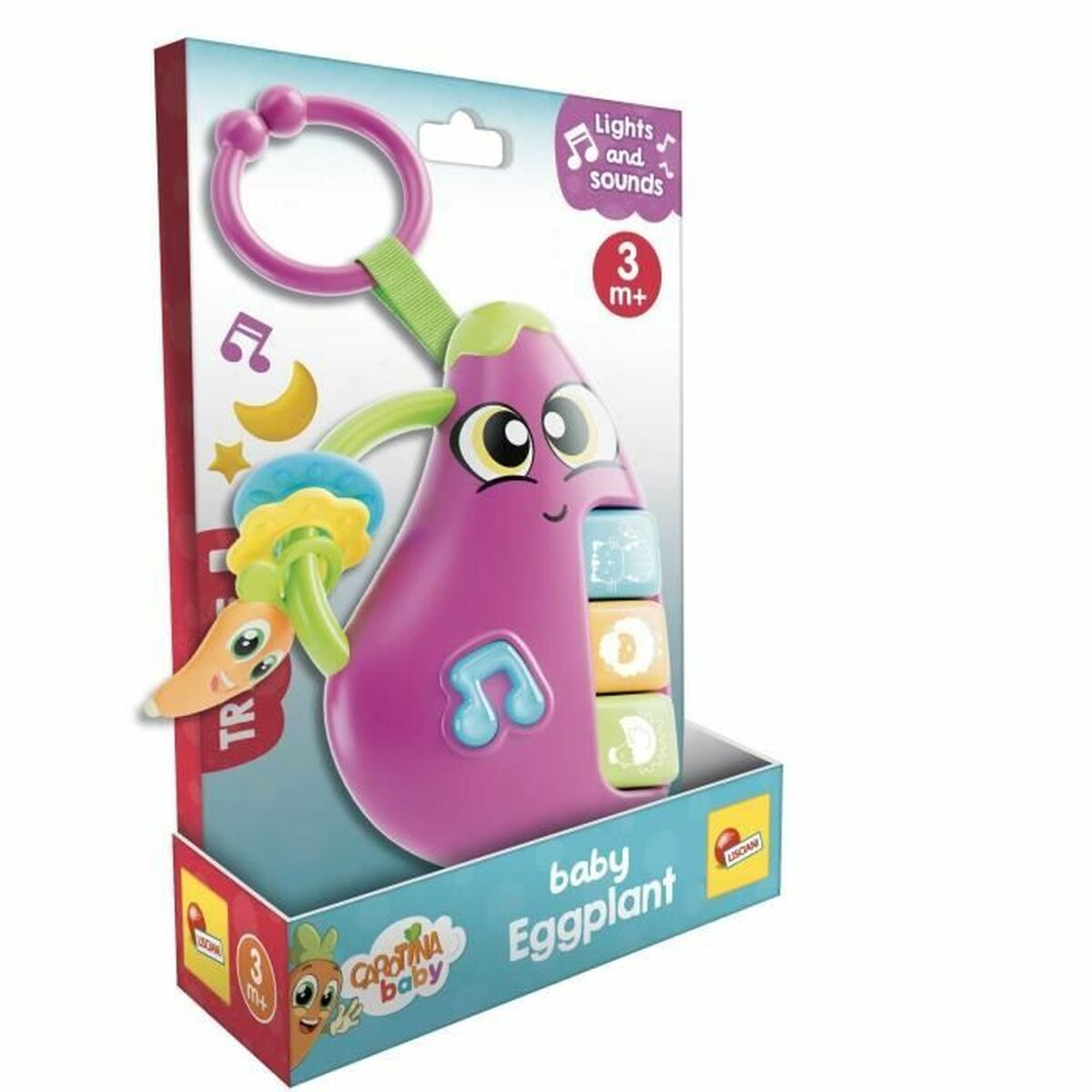 Ein Baby-Auberginen-Spielzeug in seiner Schachtel. Das Spielzeug ist lila mit Knöpfen. Die Schachtel hat Text, eine Karotte und einen Mond und Stern.
