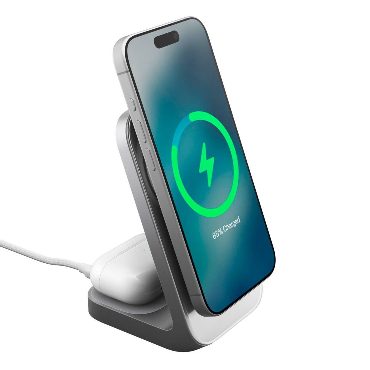 Telefon ładuje się na stojaku. Ekran pokazuje zielony symbol ładowania i 85% naładowania. Słuchawka znajduje się na stojaku.