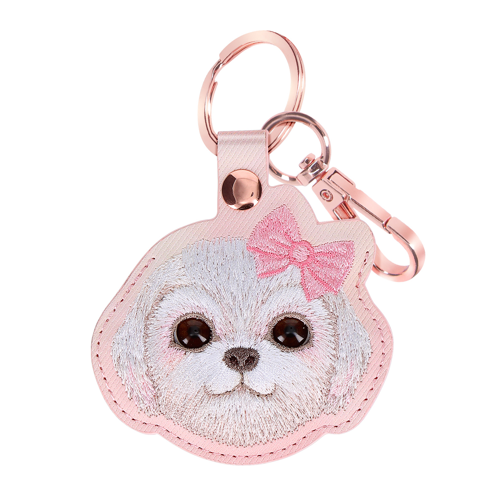 Un portachiavi a forma di cane rosa con fiocco. Ha un fermaglio e un anello di metallo.