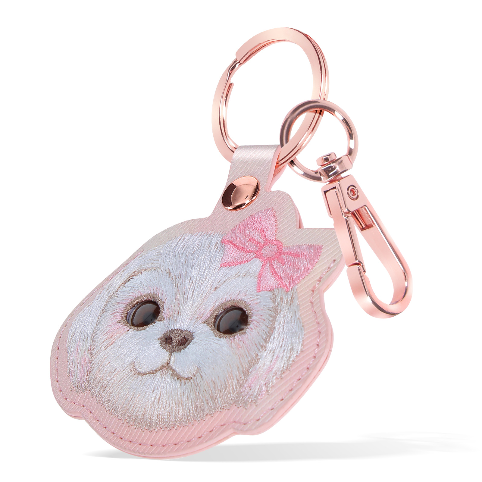 Un portachiavi a forma di cane con dettagli rosa, un fiocco e una chiusura metallica.