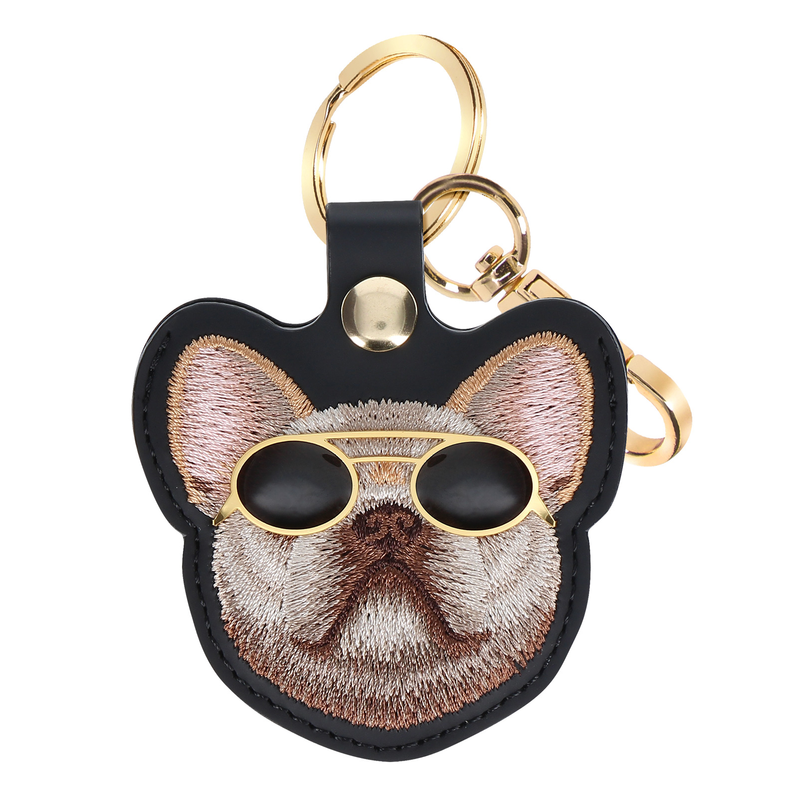 Un portachiavi a forma di cane con occhiali da sole. Ha un portachiavi dorato e dettagli in pelle nera.