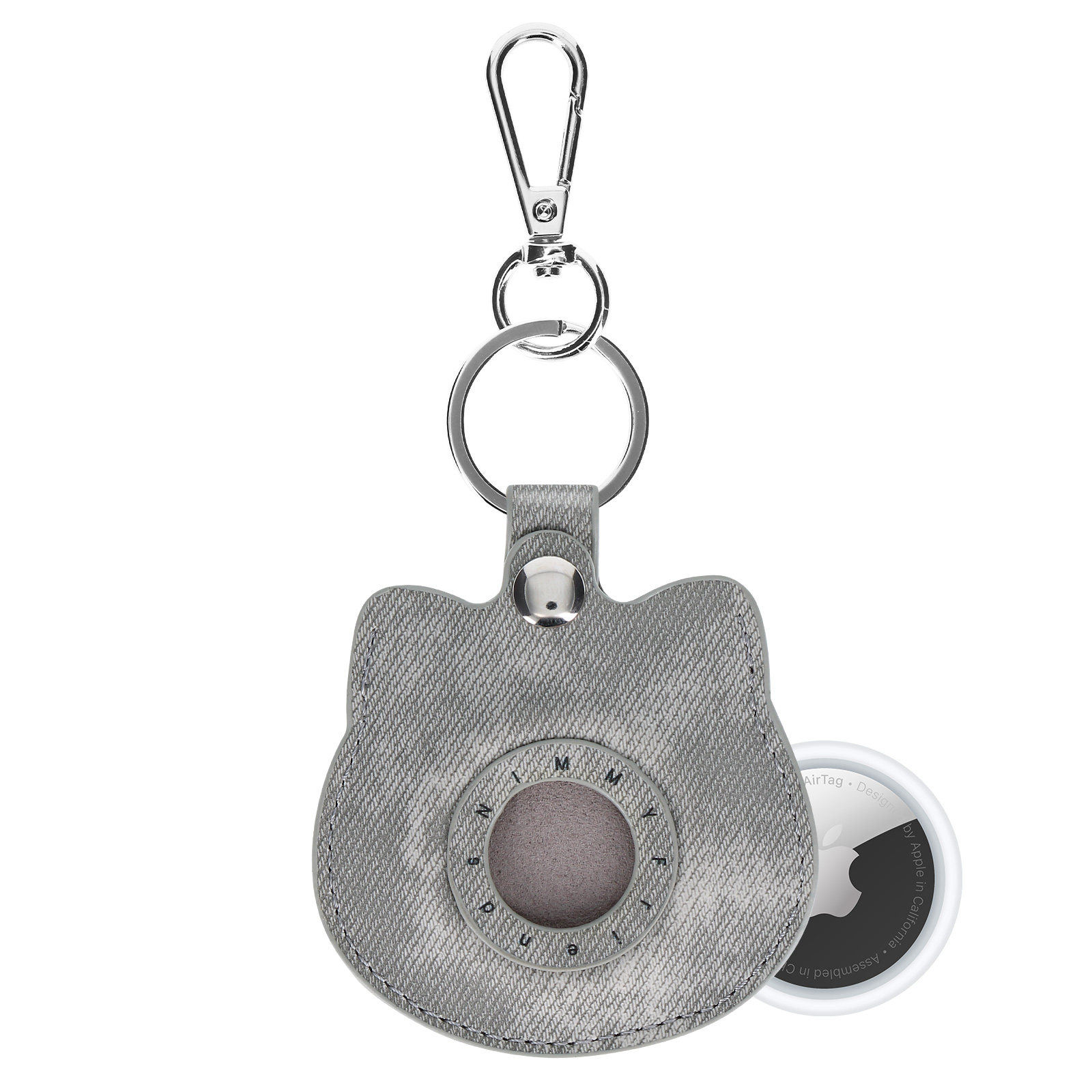 Un supporto per AirTag a forma di gatto in denim grigio con portachiavi argentato e AirTag Apple bianco.