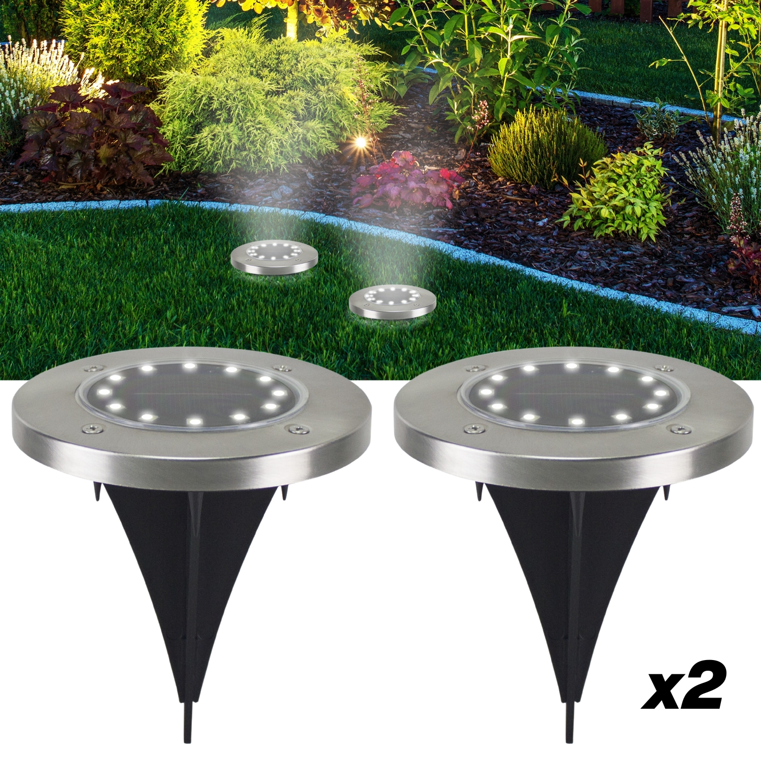 Due luci solari da giardino su un prato, con piante verdi lussureggianti sullo sfondo. Le luci hanno cime rotonde argentate e picchetti neri.