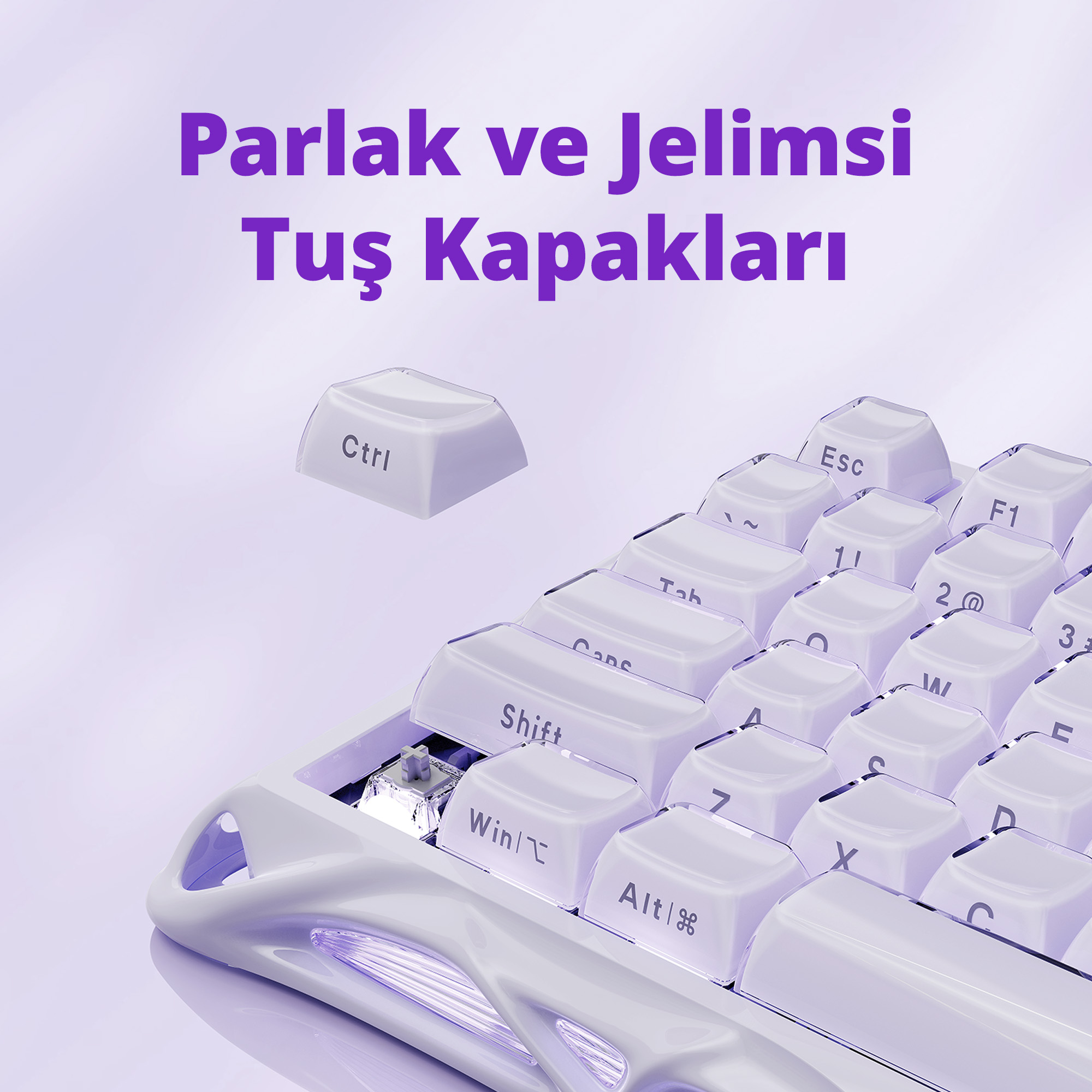 Biała klawiatura z przezroczystymi klawiszami. Klawisz 'Ctrl' unosi się. Tekst 'Parlak ve Jelimsi Tuş Kapakları' na górze.