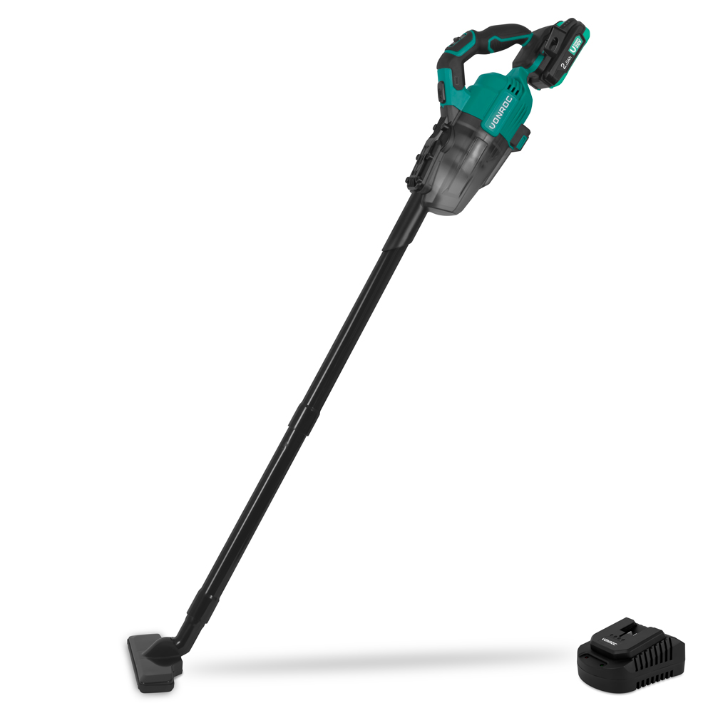 A cordless vacuum cleaner, green and black. It is on a white background. Battery charger is beside it.