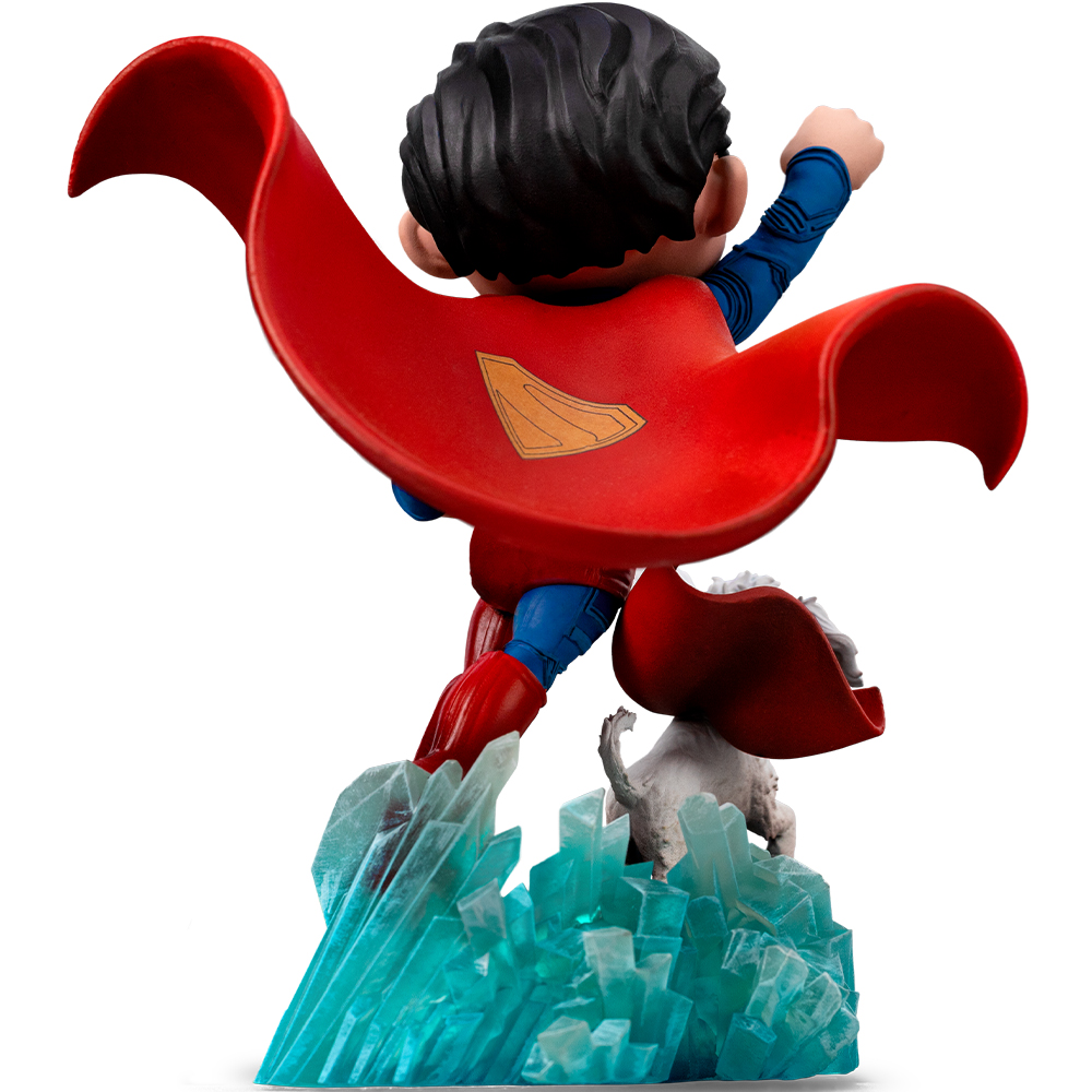 Statuetta di Superman in azione. Mantello rosso, tuta blu e un'emblema dello scudo dorato. Montato su una base di cristallo, con una creatura bianca sotto.