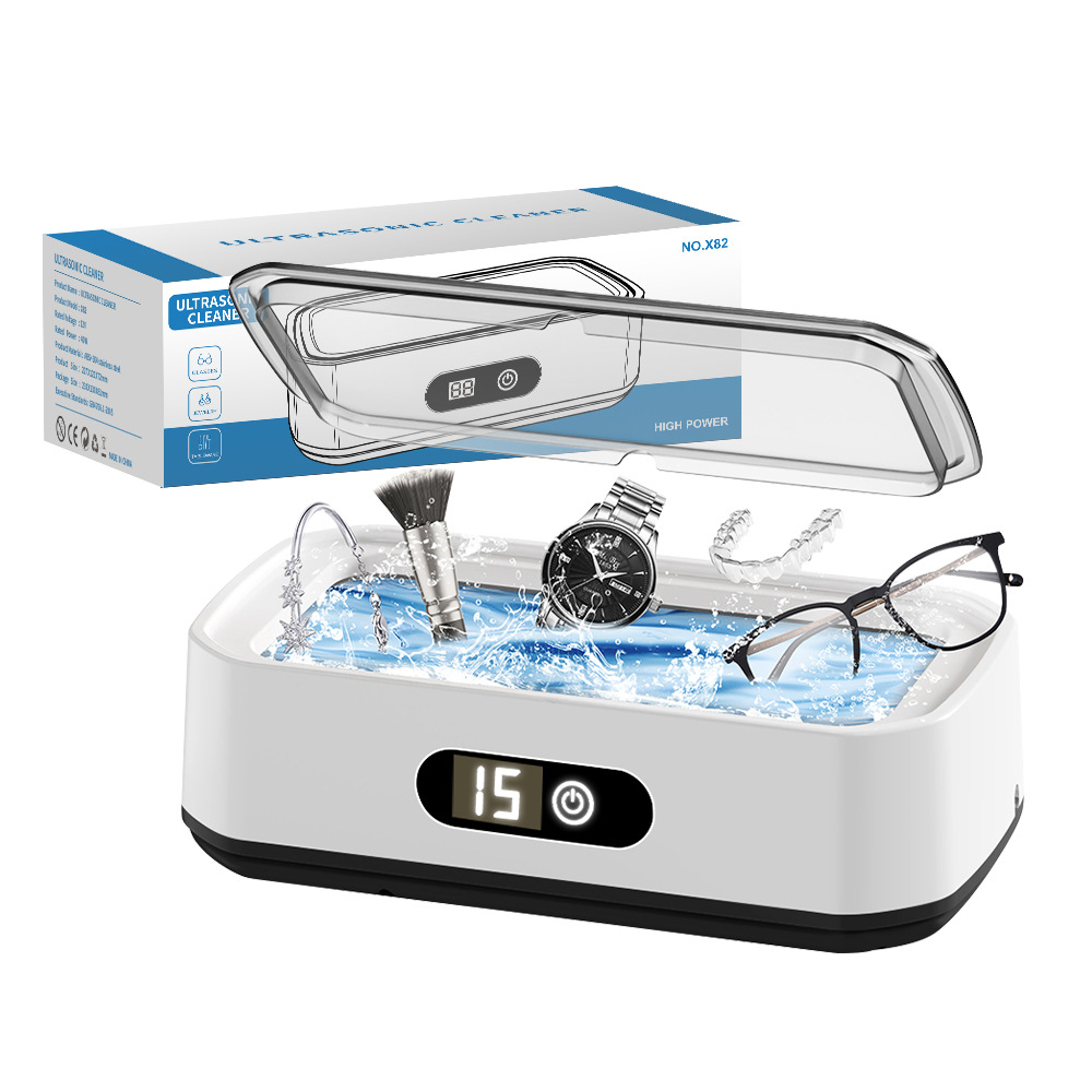 Ultraschallreiniger mit Uhr, Brille und Bürste. Oben befindet sich eine Box mit digitaler Anzeige, die 15 Minuten anzeigt.