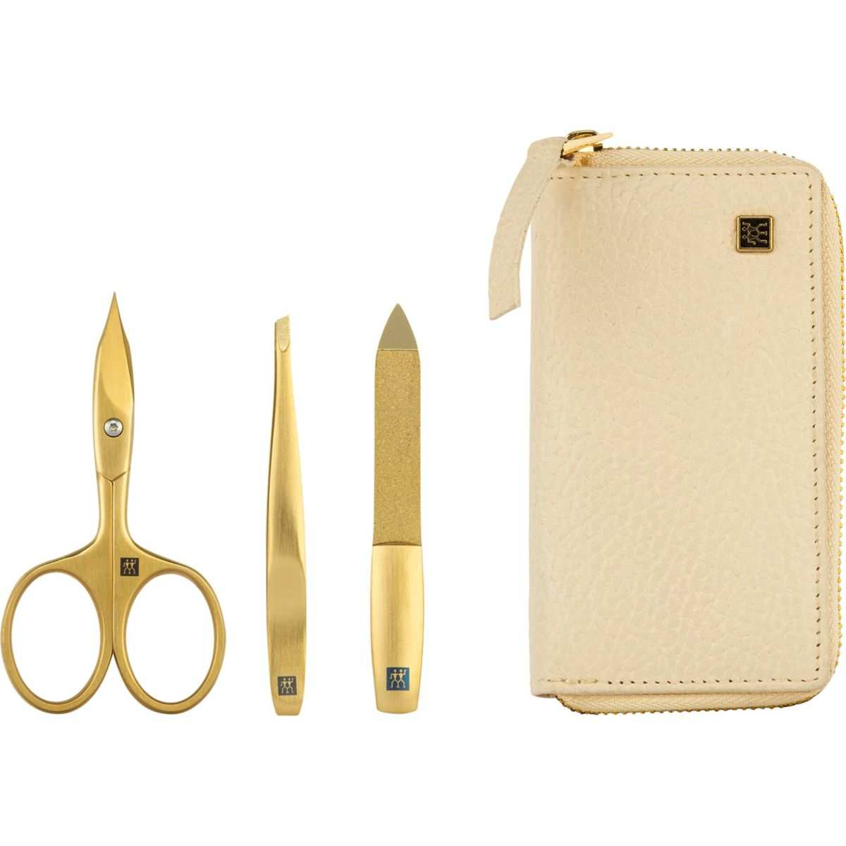 Ein Maniküre-Set mit goldener Schere, Pinzette, Nagelfeile und einem beigen Lederetui.