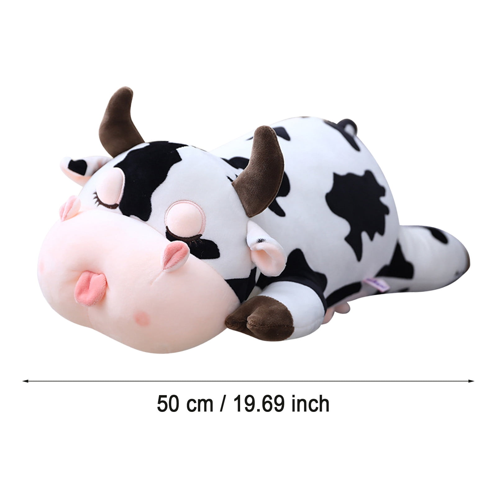 Ein Kuh-Plüschtier, weiß mit schwarzen Flecken, braunen Hörnern und Hufen, rosa Nase und Zunge, liegt. Unten ist ein Maß von 50 cm.