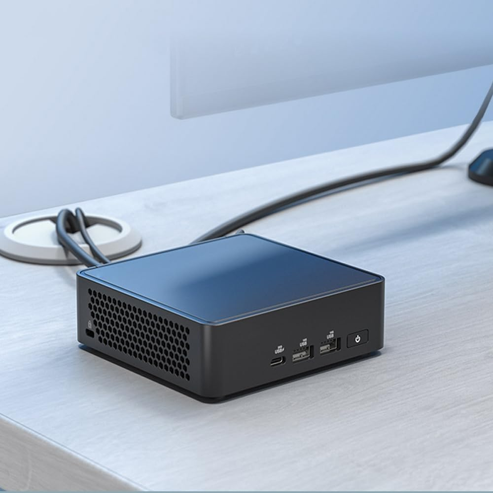 Czarny mini PC na drewnianym biurku z podłączonymi kablami. Widoczne są również monitor, mysz i funkcje zarządzania kablami.