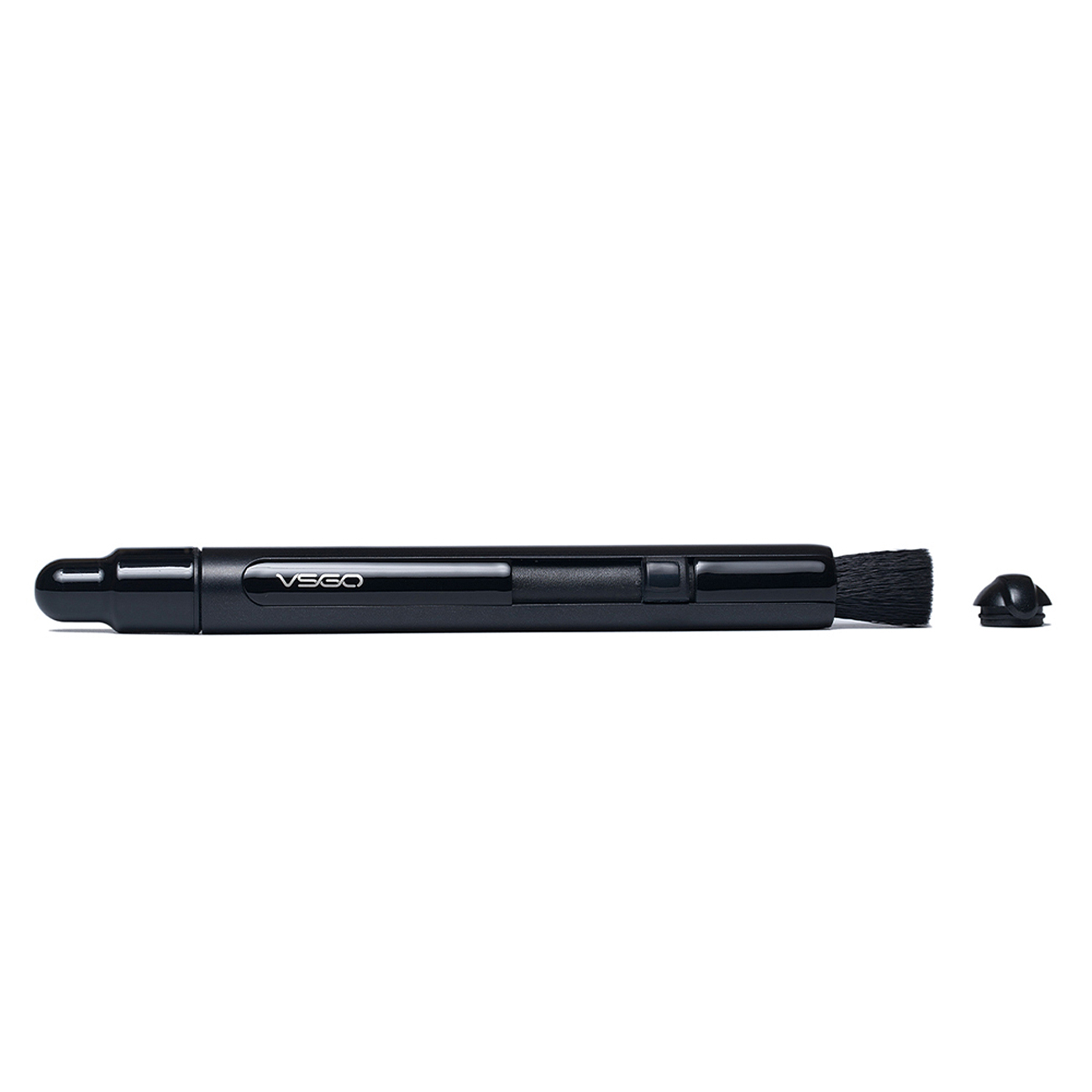 Ein schwarzer Objektivreiniger-Stift, mit einer Bürste an einem Ende und einer Kappe. Der Stift liegt auf weißem Hintergrund.
