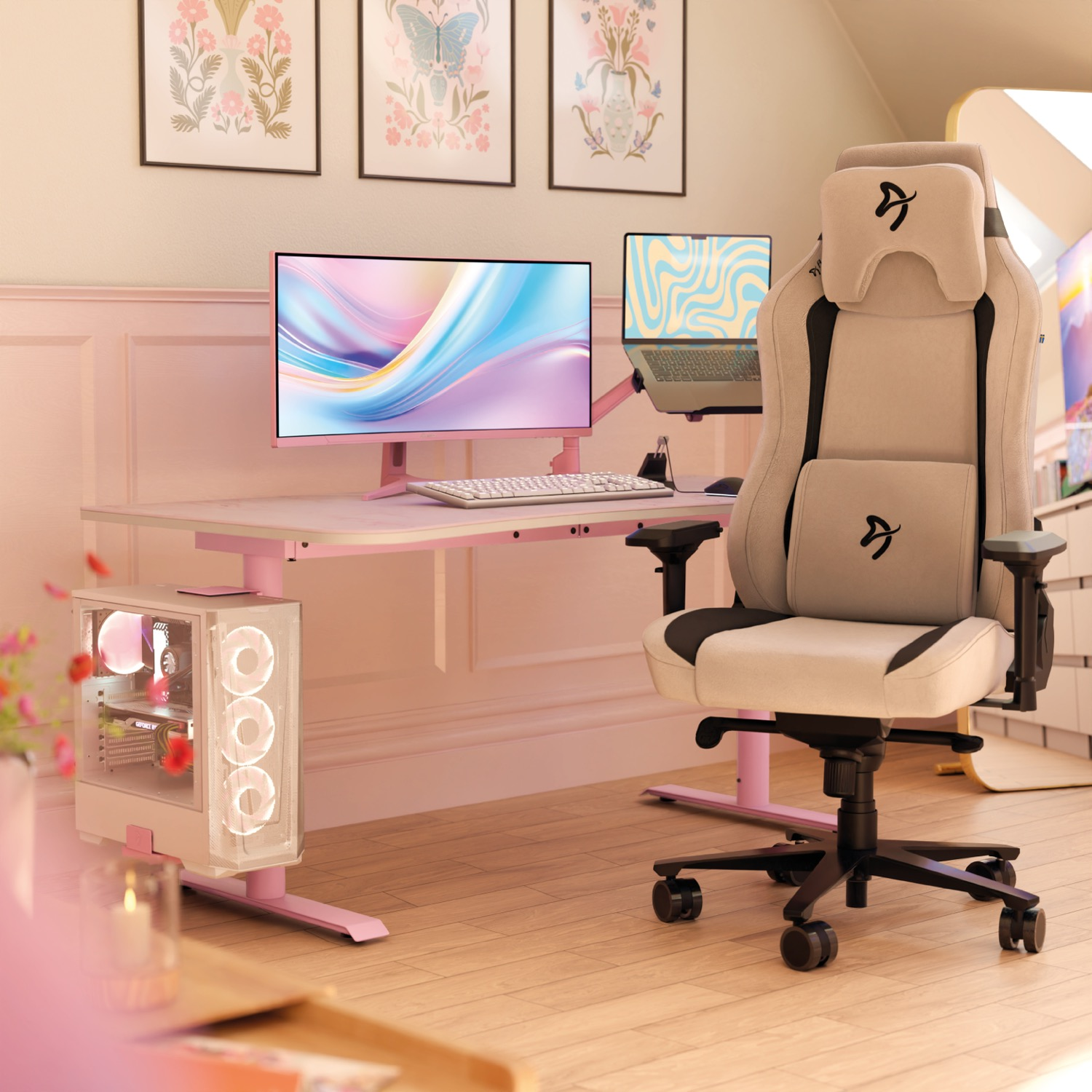 Konfiguracja do gier z różowym biurkiem, czarno-białym krzesłem, komputerem, monitorem i dziełami sztuki na ścianie.