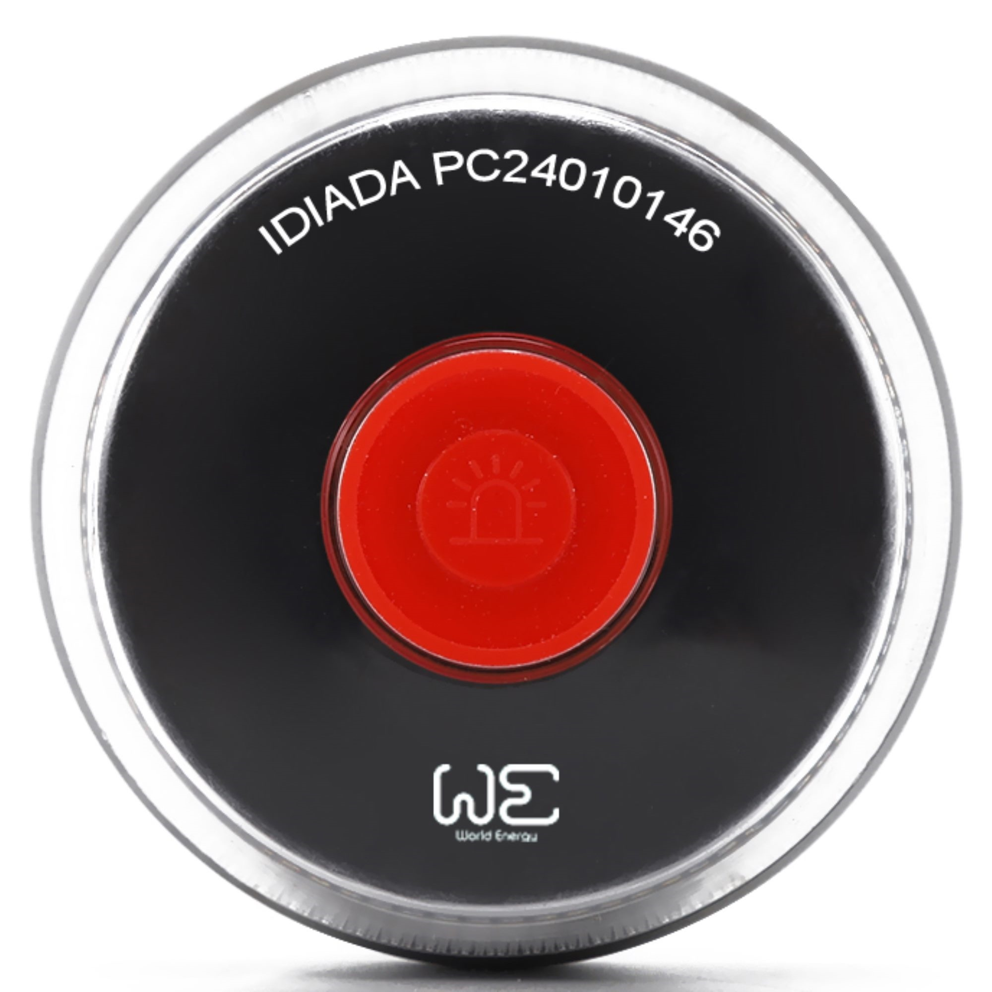 Un botón redondo negro con centro rojo. Tiene texto y un símbolo de sirena. El botón está rodeado por un anillo de plástico transparente.
