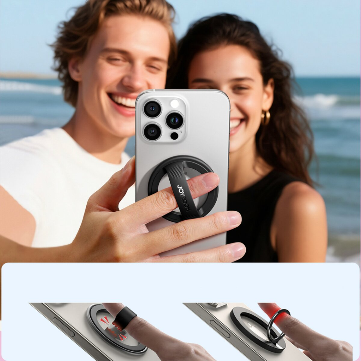 Ein Paar lächelt, während es ein Telefon mit einem Ringgriff hält. Das Telefon ist silberfarben. Der Hintergrund ist der Strand.