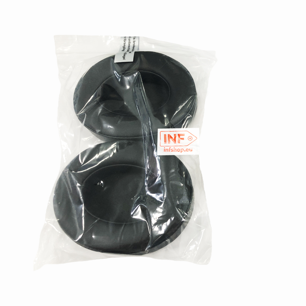 Dos almohadillas circulares negras empaquetadas en bolsa transparente. Una etiqueta blanca con texto rojo está adherida.